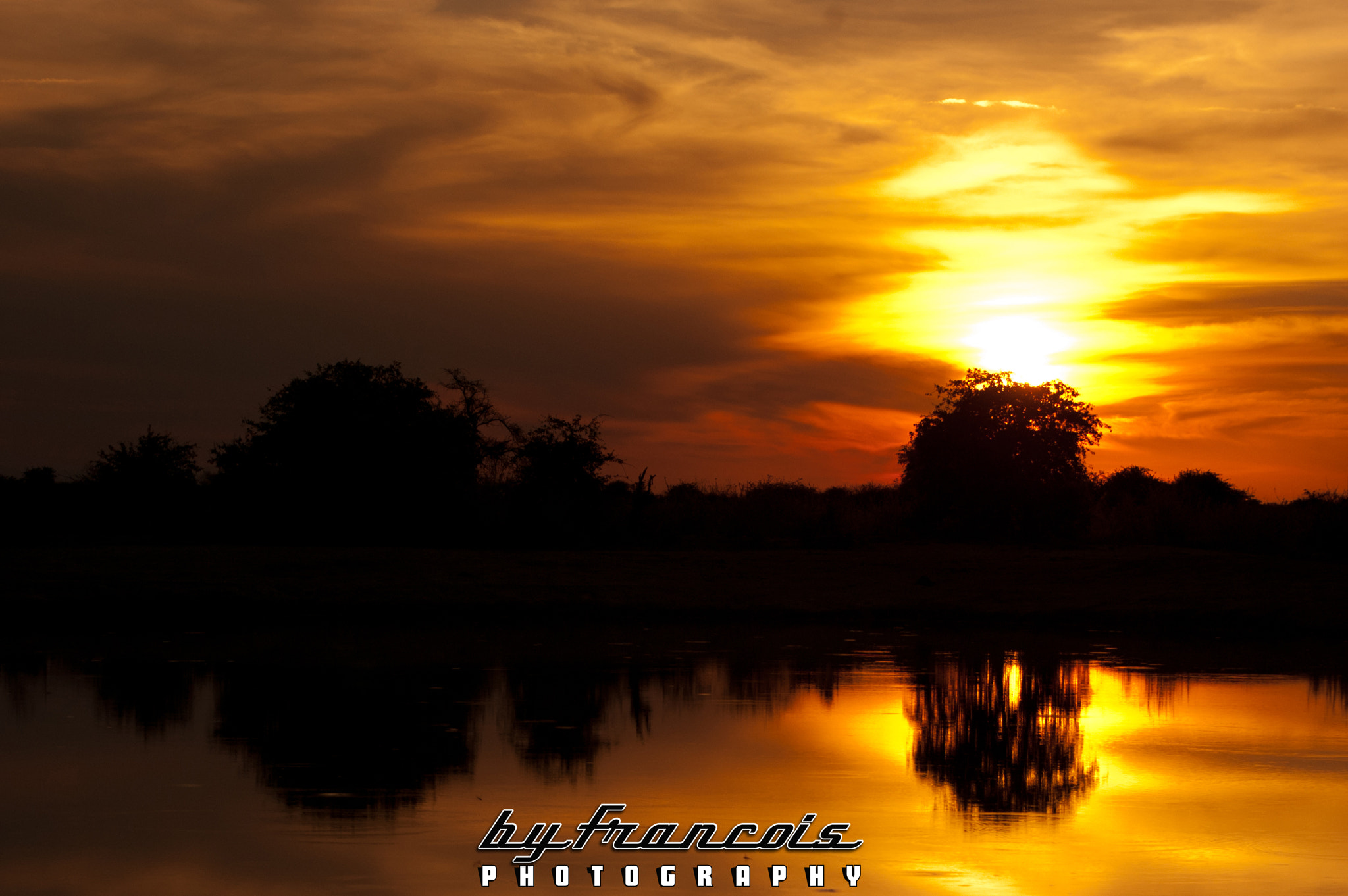 Nikon D40 + Nikon AF-S Nikkor 70-300mm F4.5-5.6G VR sample photo. Sunset over a watering hole in botswana photography