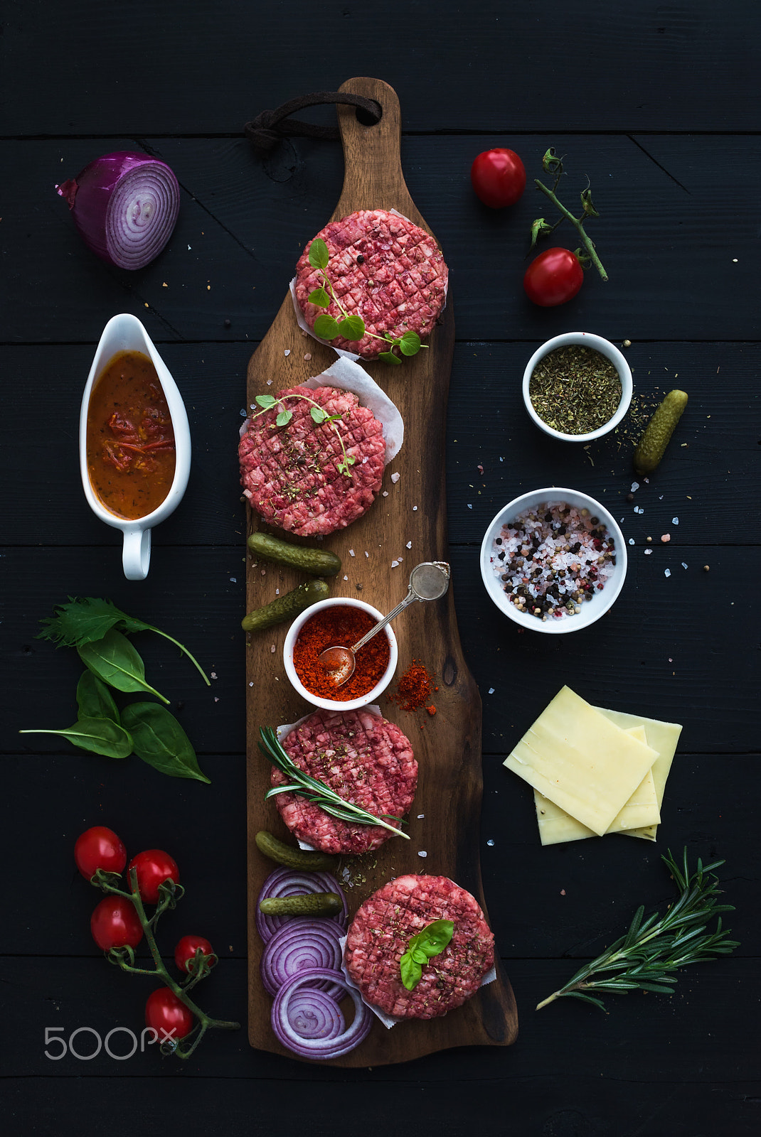 Nikon D610 + ZEISS Distagon T* 35mm F2 sample photo. Ingredients for cooking burgers. raw ground beef meat cutlets on wooden chopping board, red onion, c photography
