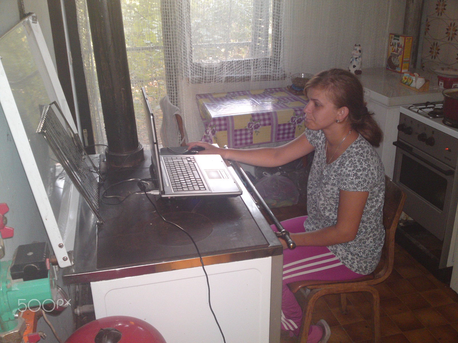 Sony Ericsson U1i sample photo. Girl whit lap top on kitchen stove photography