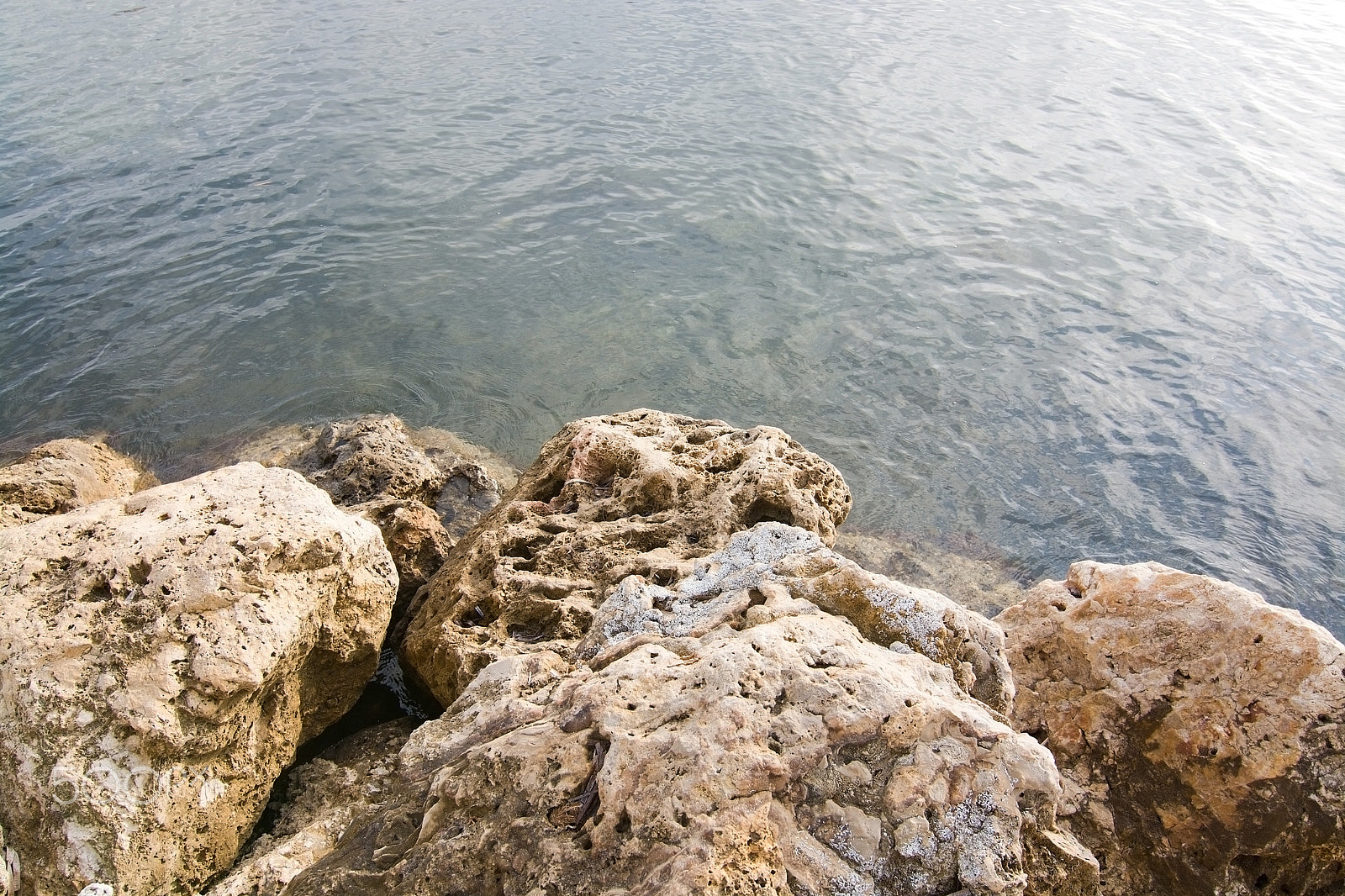 Sigma 18-125mm F3.8-5.6 DC OS HSM sample photo. Rocks and sea background photography