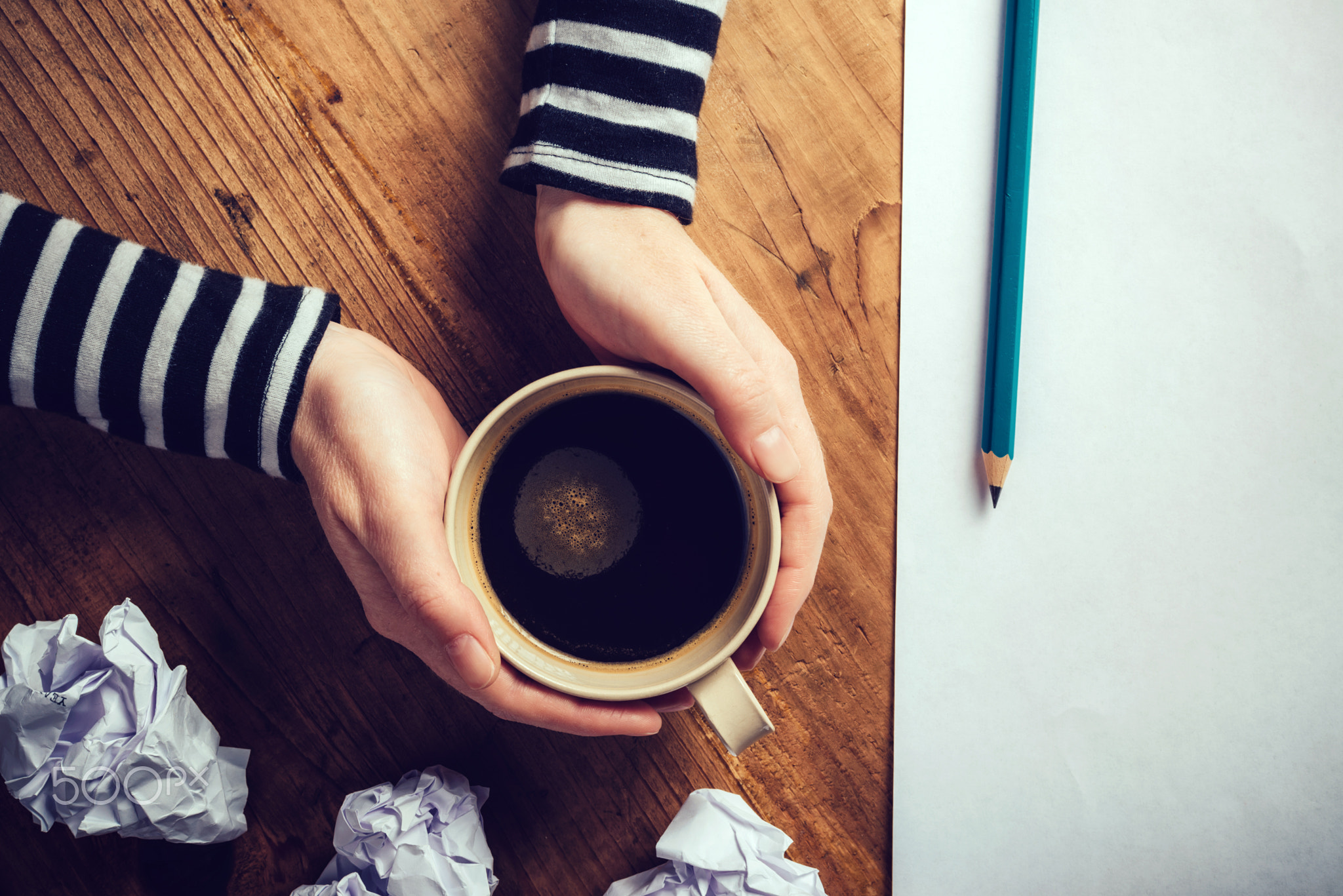 Female writer drinking cup of coffee