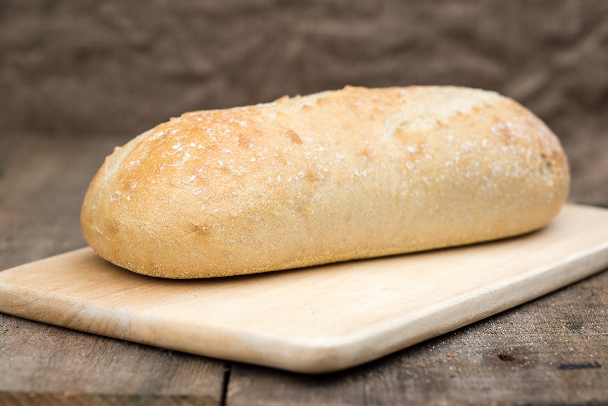 Nikon D600 + Sigma 105mm F2.8 EX DG Macro sample photo. Loaf of sourdough bread in rustic kitchend setting photography