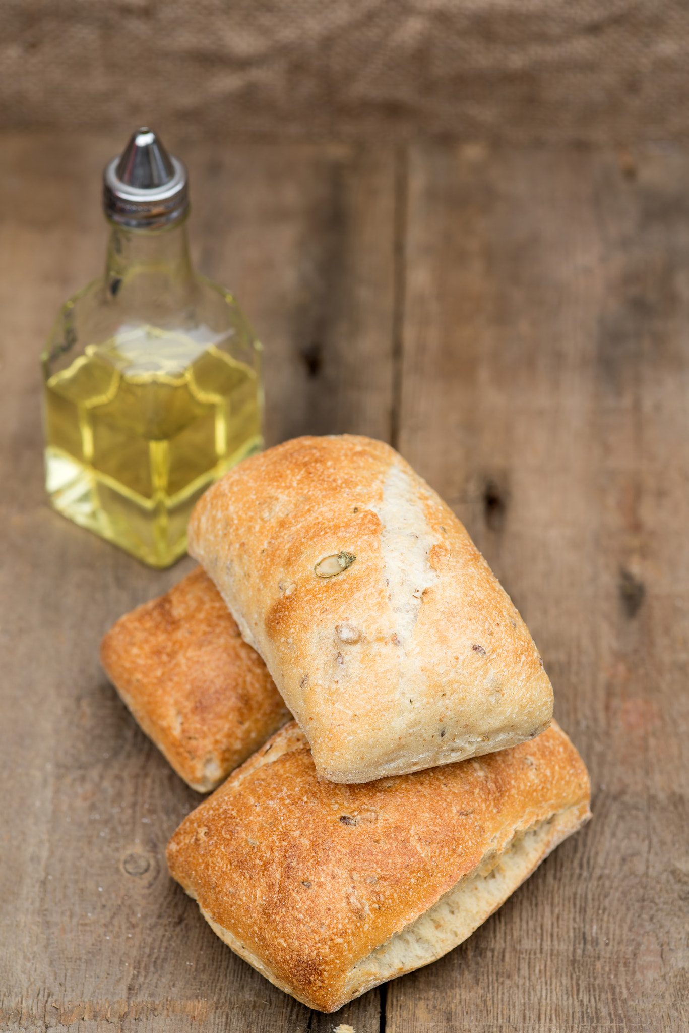 Nikon D600 + Sigma 105mm F2.8 EX DG Macro sample photo. Olive bread rollis in rustic kitchen setting with utensils photography