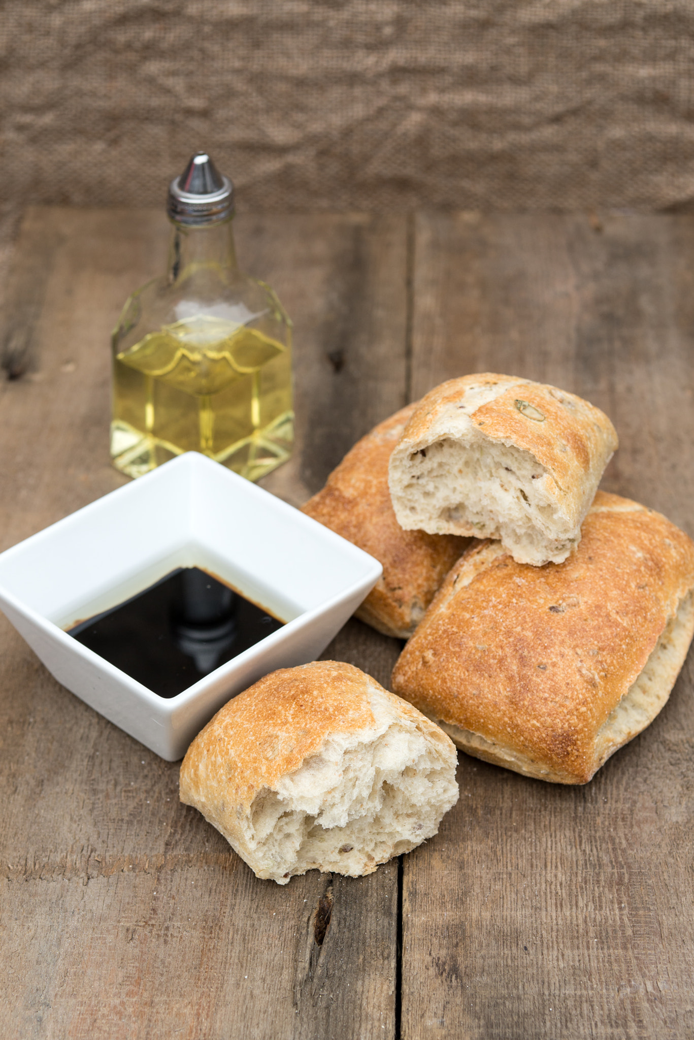 Nikon D600 + Sigma 105mm F2.8 EX DG Macro sample photo. Olive bread rollis in rustic kitchen setting with utensils photography