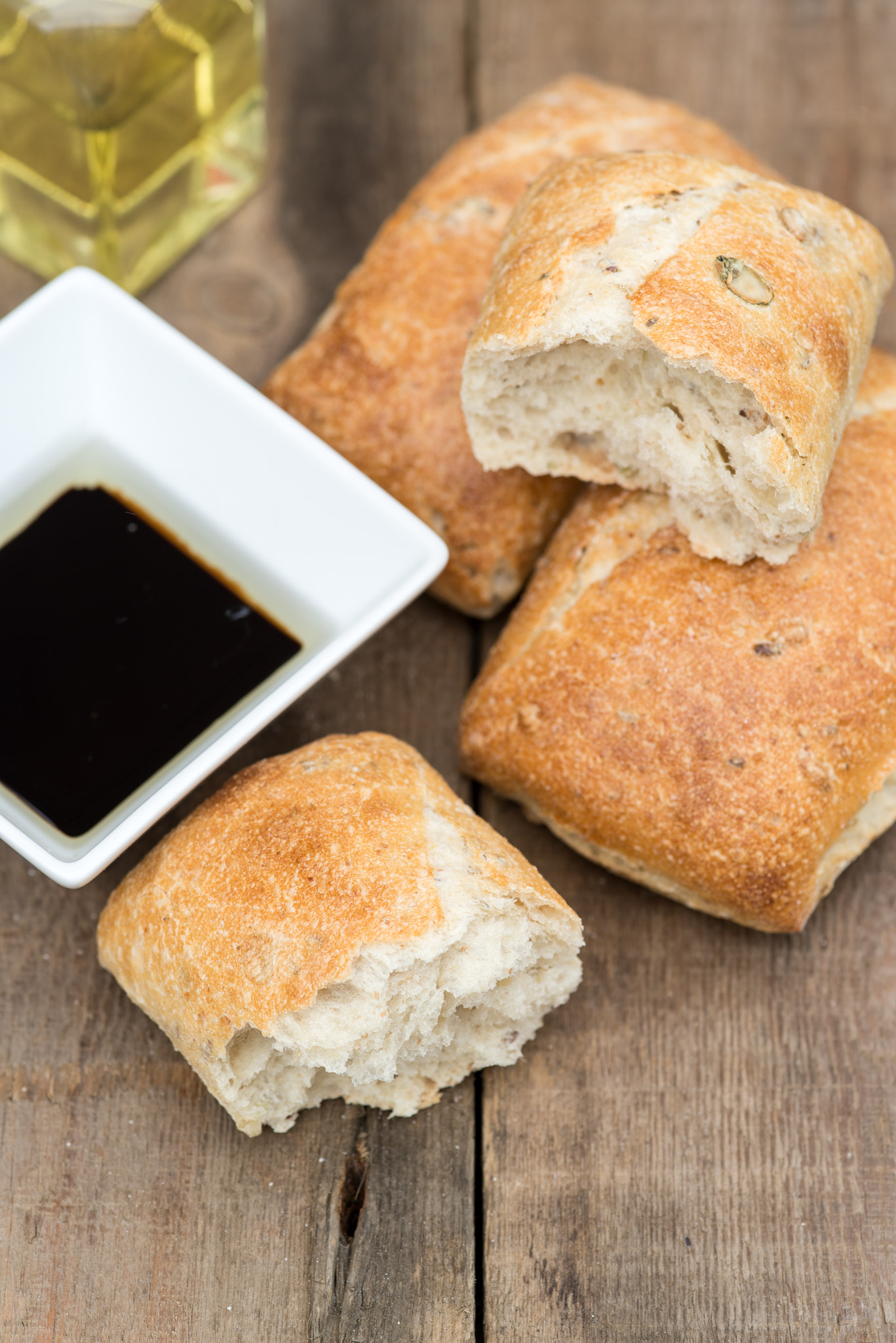 Nikon D600 + Sigma 105mm F2.8 EX DG Macro sample photo. Olive bread rollis in rustic kitchen setting with utensils photography