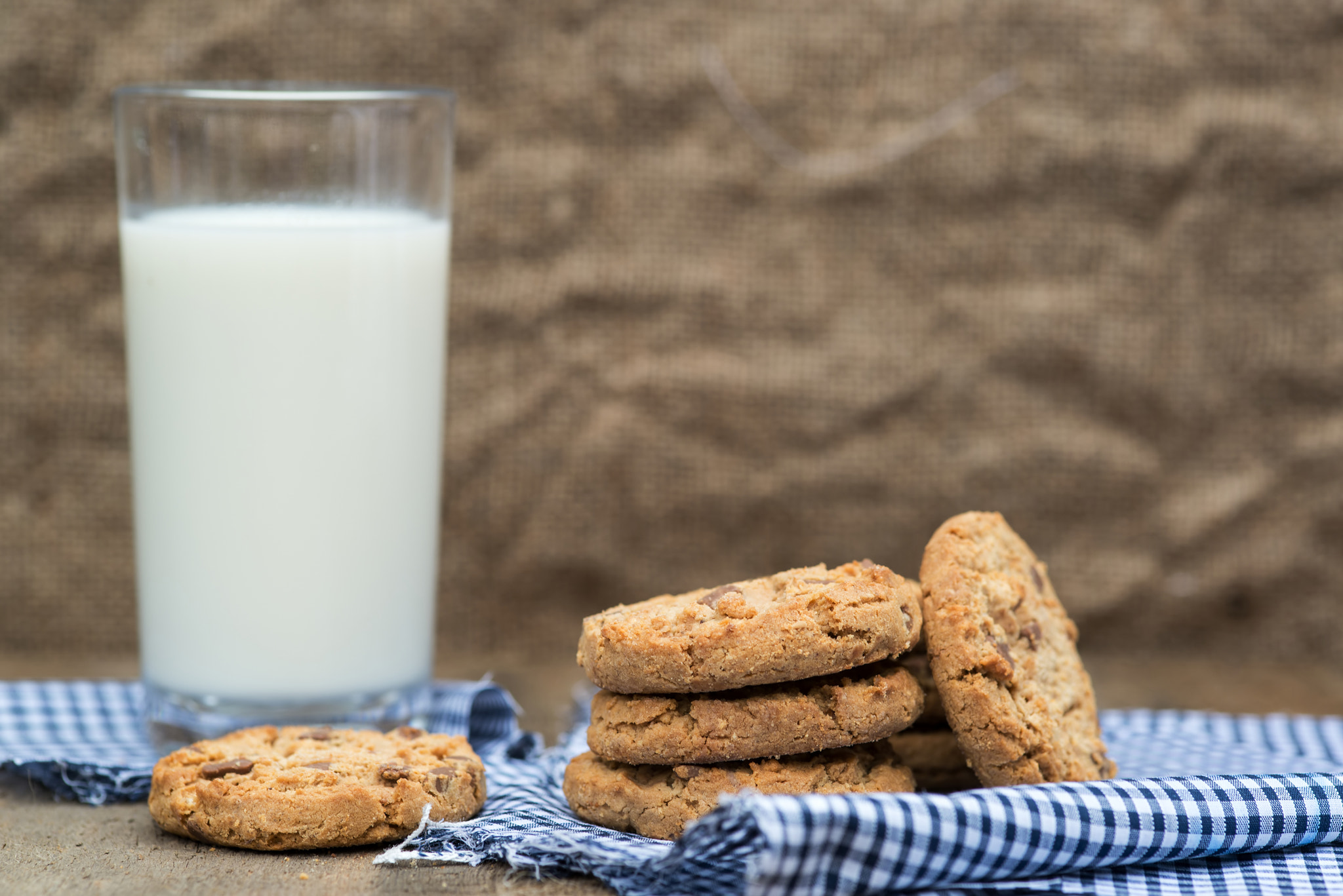 Nikon D600 + Sigma 105mm F2.8 EX DG Macro sample photo. Rustic setting with chocolate chip cookies and glass of milk photography