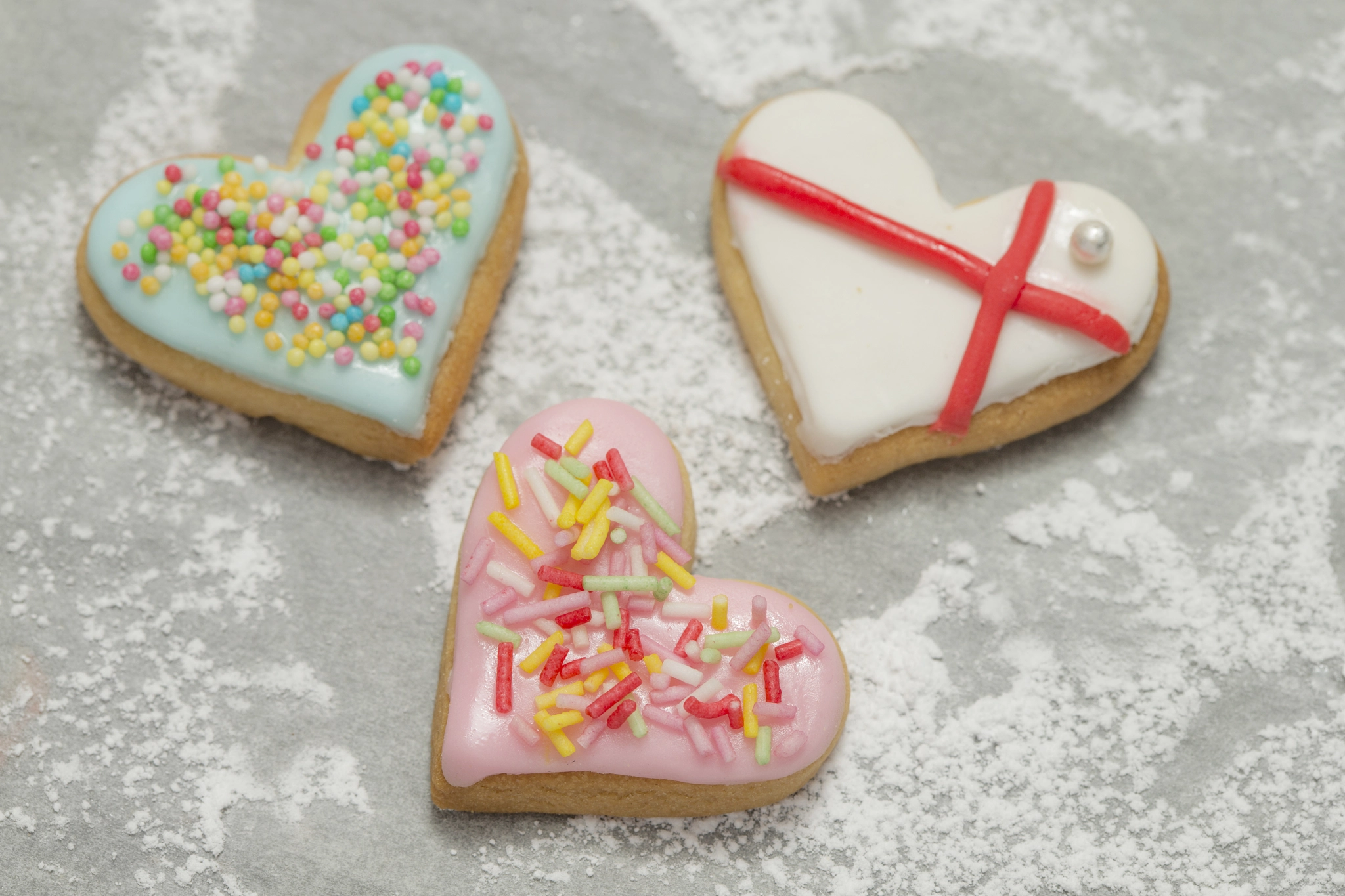 Canon EOS-1D X + Canon EF 100mm F2.8 Macro USM sample photo. Three baked valentine's hearts on powdered background photography