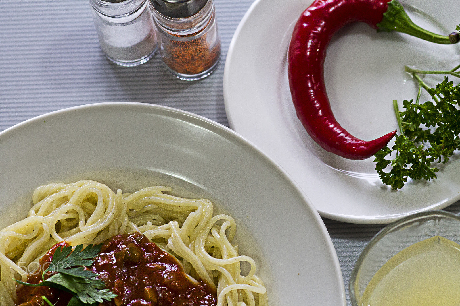 Canon EF 100mm F2.8 Macro USM sample photo. Plates with spaghetti sauce red pepper parsley and glass of grapefruit juice photography