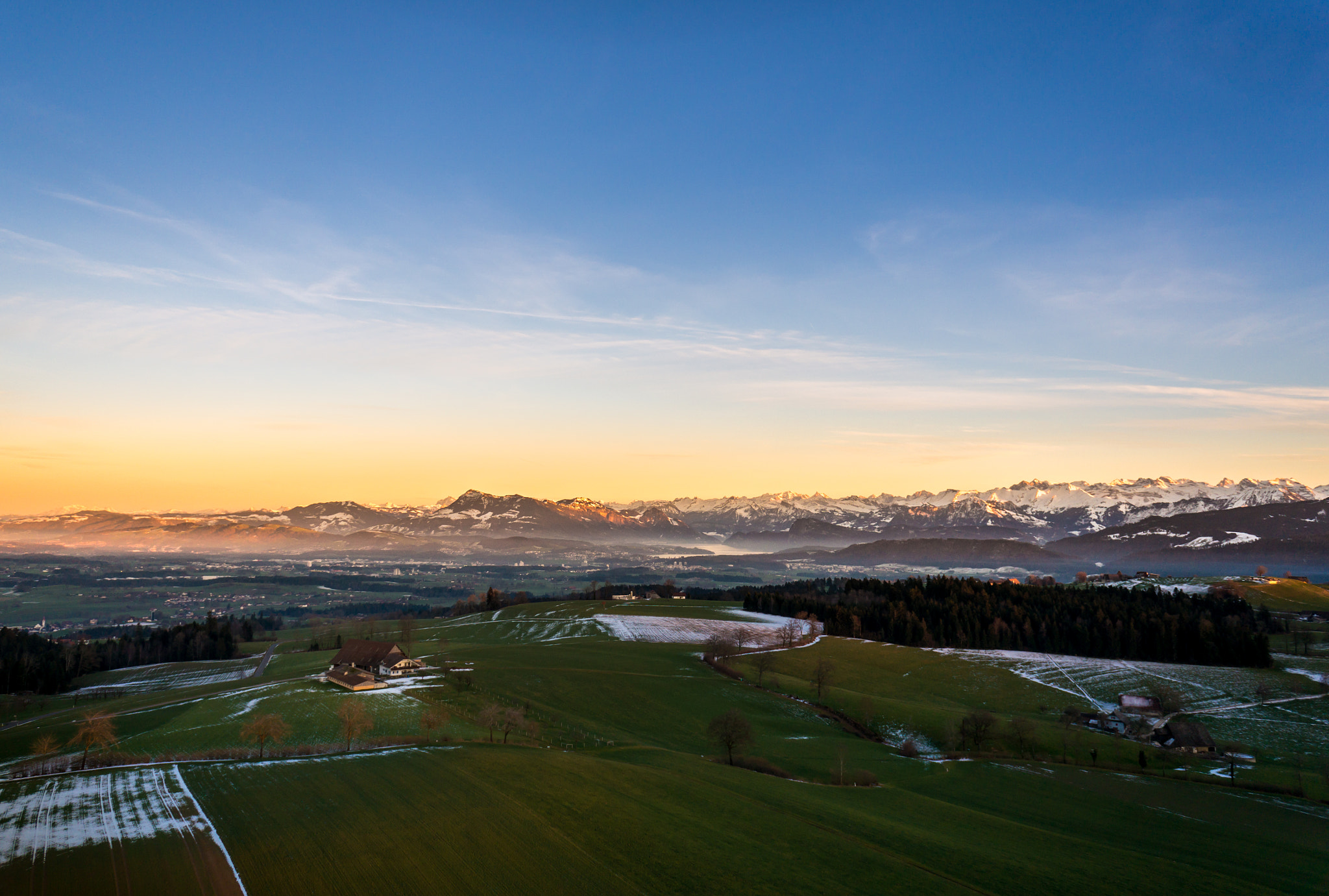 Sony Alpha NEX-5T + Sony E 16mm F2.8 sample photo. Drone image of a sunset in switzerland photography