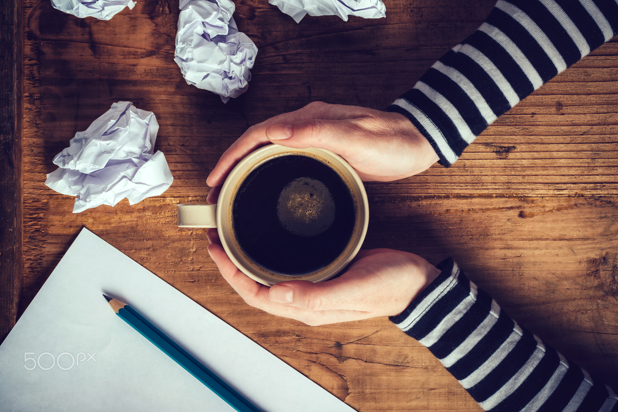 Female writer drinking cup of coffee