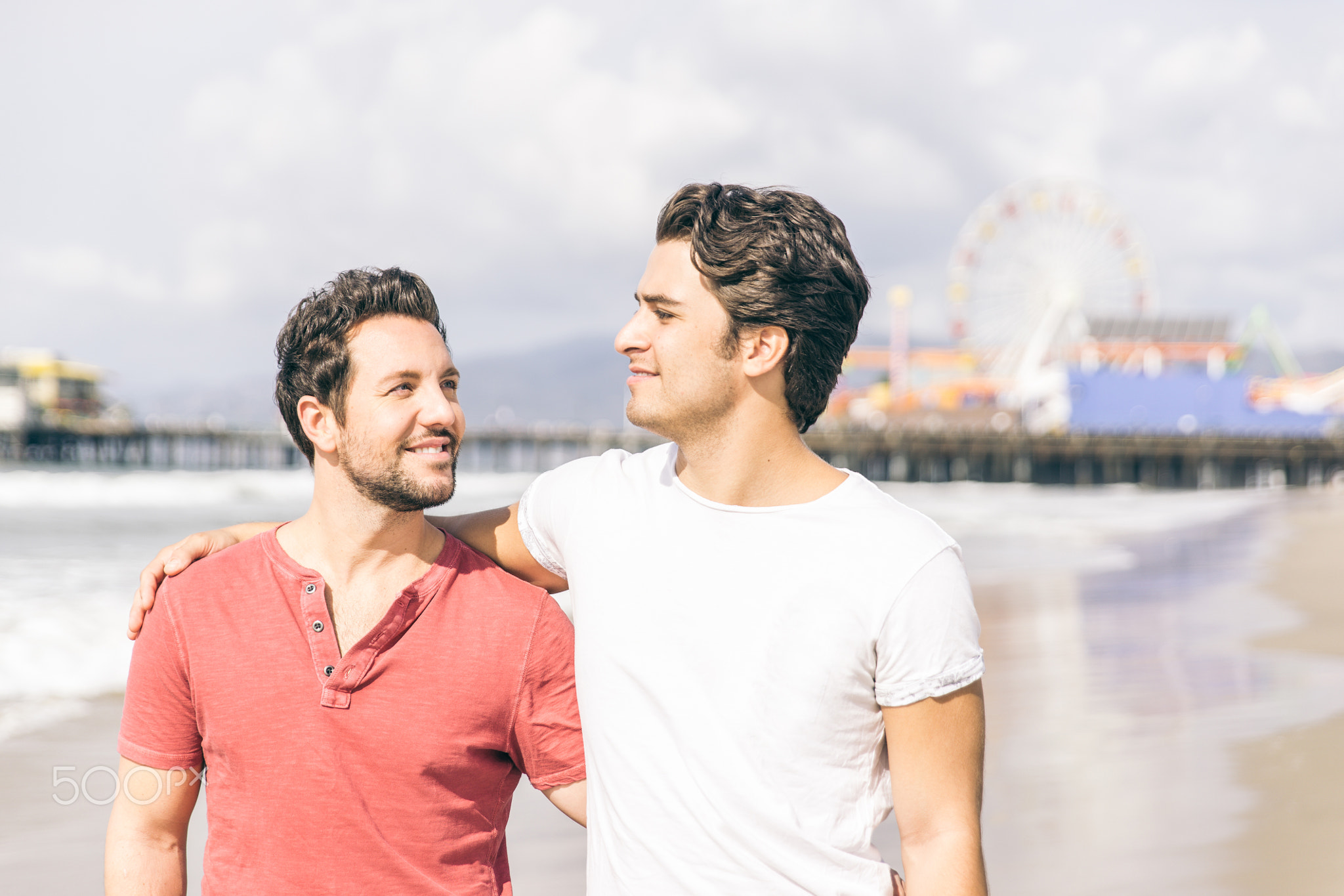 happy couple in love walking in Santa monica on the beach