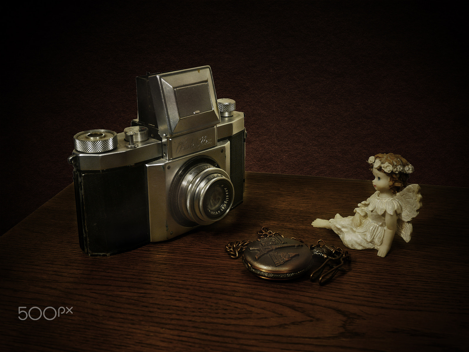 LUMIX G VARIO PZ 14-42/F3.5-5.6 sample photo. Old german camera, pocket watch and figurine photography