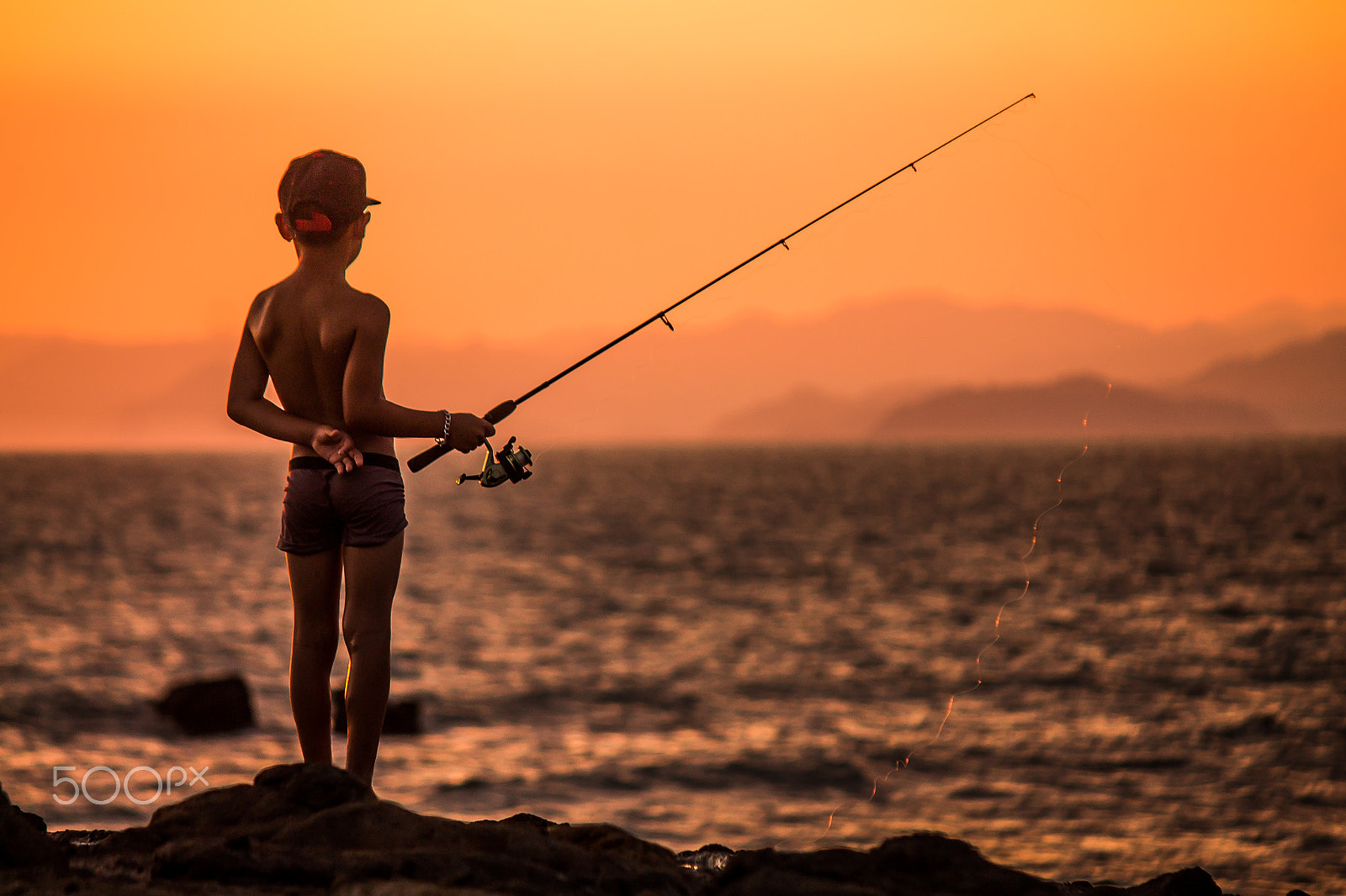 Canon EF-S 55-250mm F4-5.6 IS sample photo. Fisher at the sunset... photography