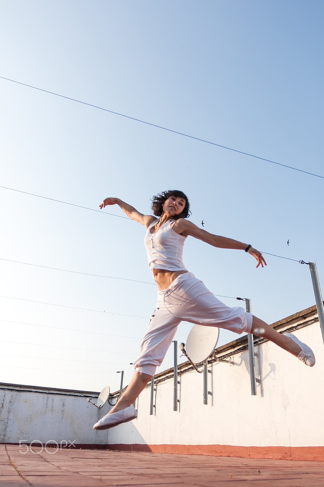 Canon EOS 30D + Canon EF 17-40mm F4L USM sample photo. Jumping at rooftop photography