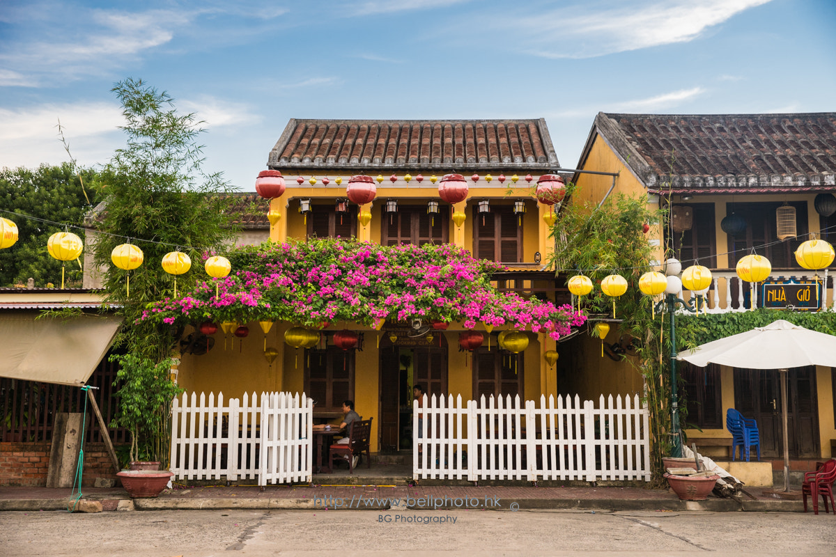 Sony a7 + Canon EF 85mm F1.2L II USM sample photo. Butter yellow buildings. photography