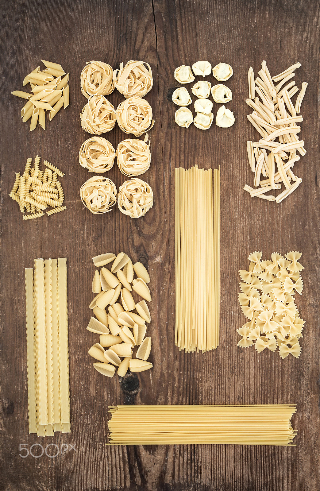 Nikon D610 + ZEISS Distagon T* 35mm F2 sample photo. Different types of italian uncooked pasta on rustic wooden table background, top view. photography