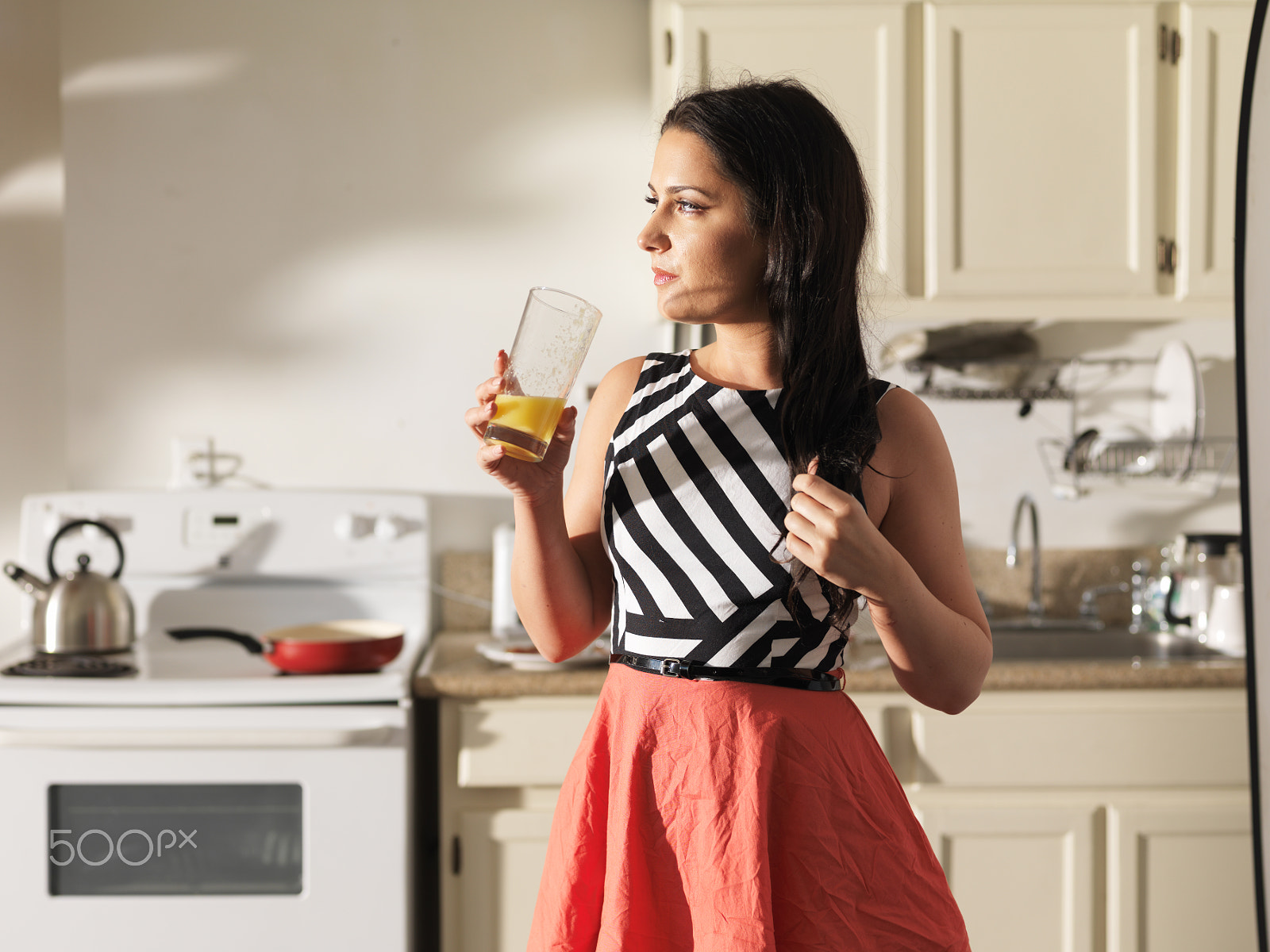 Hasselblad H3DII-39 + HC 80 sample photo. Woman drinking orange juice in kitchen wearing retro dress photography
