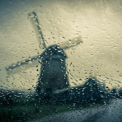 Sony E 18-200mm F3.5-6.3 OSS sample photo. Dutch windmill in the rain photography