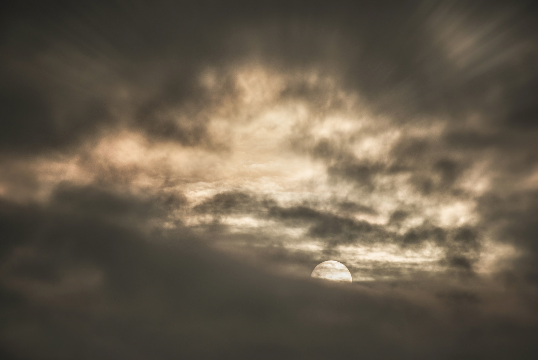 Sony Alpha DSLR-A230 sample photo. Sun and moon behind the clouds. photography