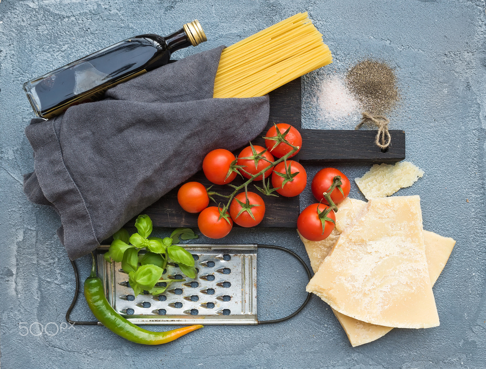 Nikon D610 + ZEISS Distagon T* 35mm F2 sample photo. Ingredients for cooking pasta. spaghetti, parmesan cheese, cherry tomatoes, metal grater, olive... photography