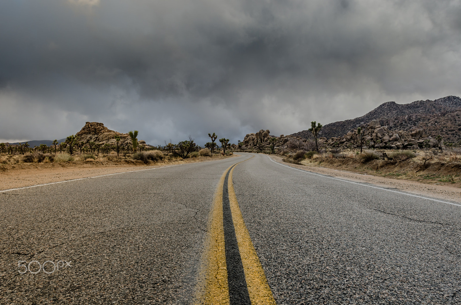 Nikon AF-S Nikkor 17-35mm F2.8D ED-IF sample photo. Middle of desert road just before a storm photography