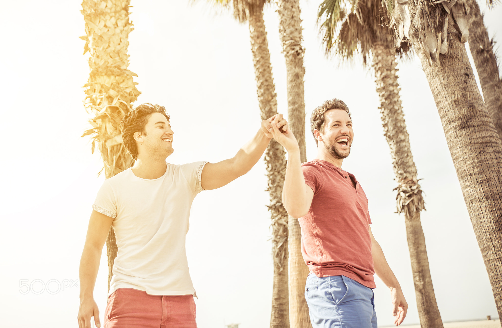 happy couple in love playing in Santa monica on the beach