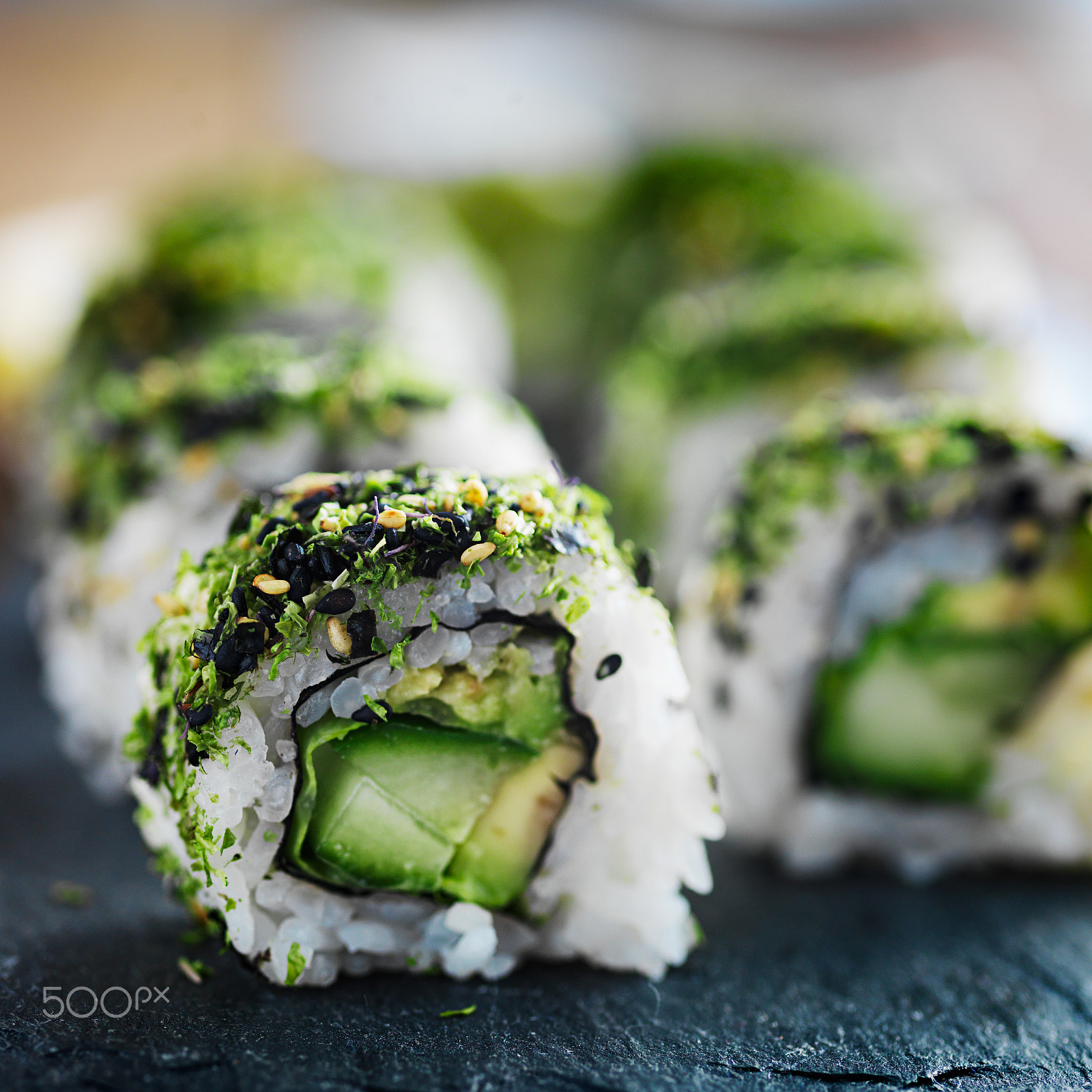 HC 120 sample photo. Healthy green kale and avocado sushi roll on slate close up photography