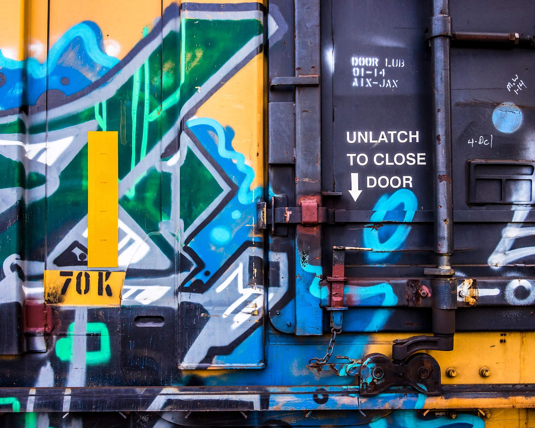 Olympus PEN E-PL3 + Panasonic Lumix G 20mm F1.7 ASPH sample photo. Train door graffiti photography