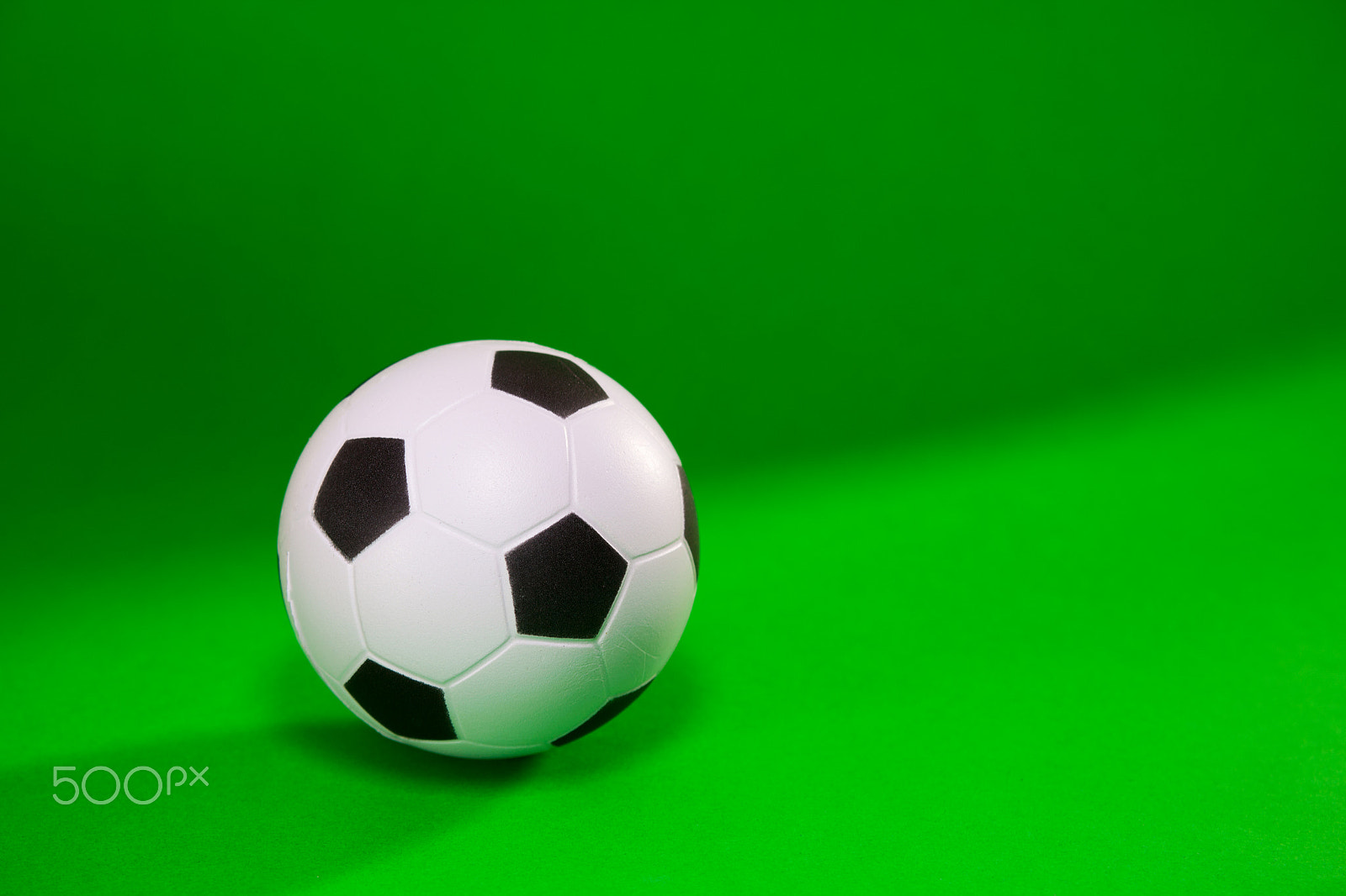 Canon EF 28-90mm f/4-5.6 sample photo. Small soccer ball over green background photography
