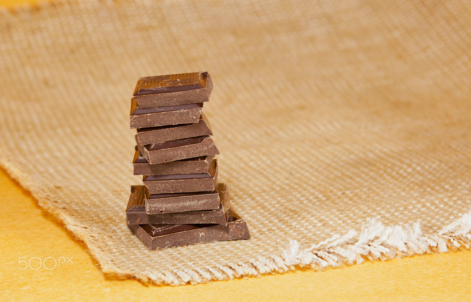 Canon EOS 5D Mark II + Canon EF 28-90mm f/4-5.6 sample photo. Chocolate stacked into bar photography