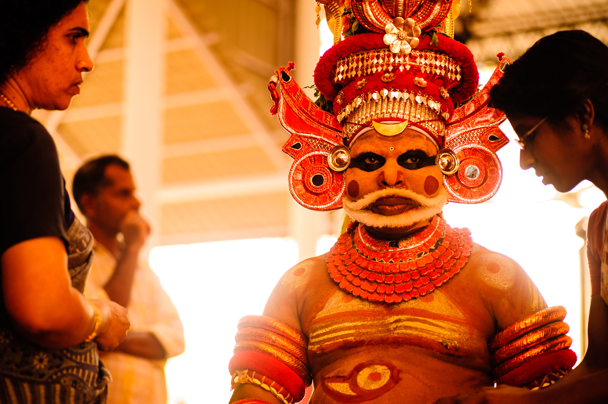 Nikon D700 + Tamron SP 90mm F2.8 Di VC USD 1:1 Macro sample photo. A theyyam dancer gives an answer to a visitor photography