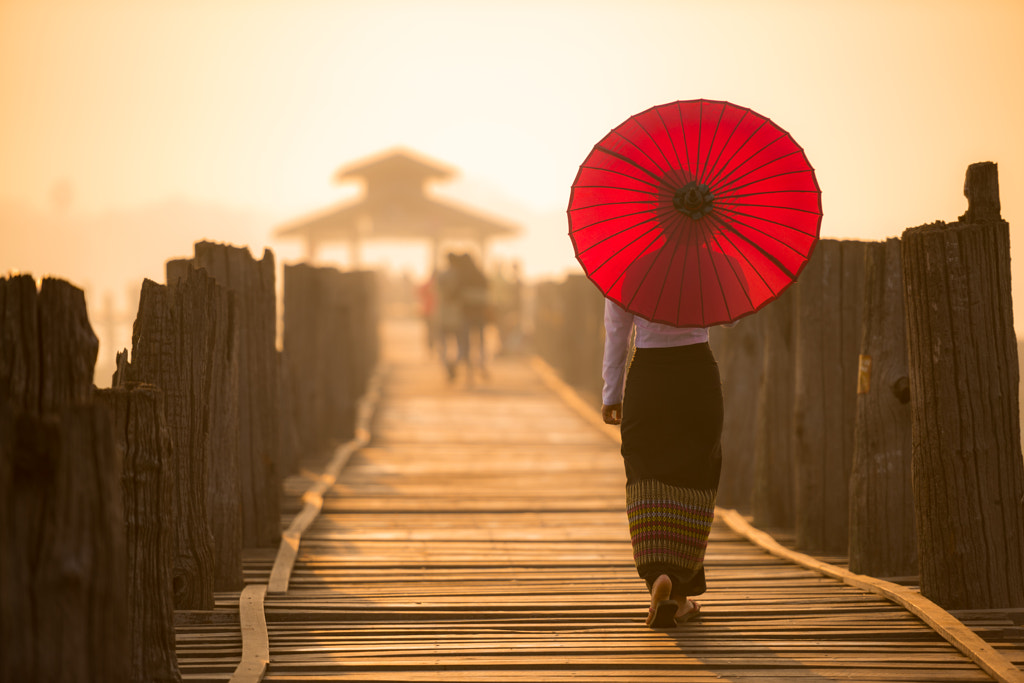 Unidentified Burmese woman walking on U Bein Bridge by Anusorn Sutapan on 500px.com