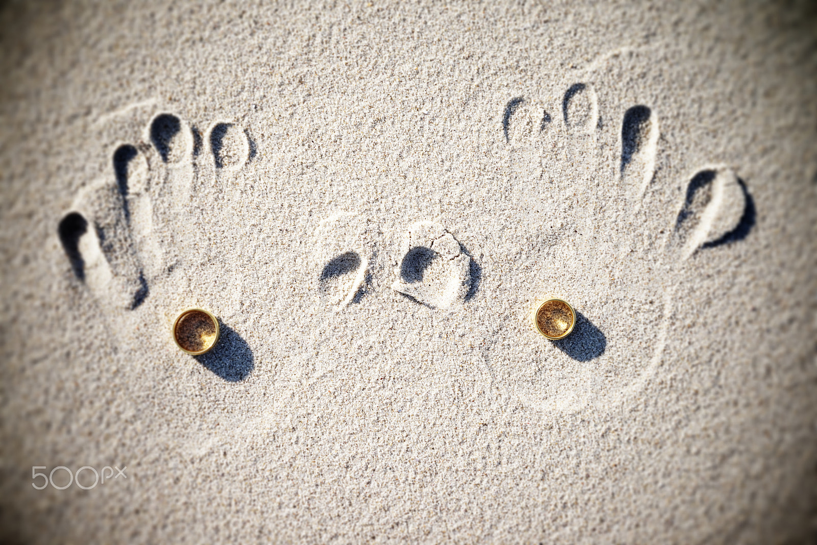 Sony a7R + Sony 50mm F2.8 Macro sample photo. Wedding rings at the beach with handprints photography