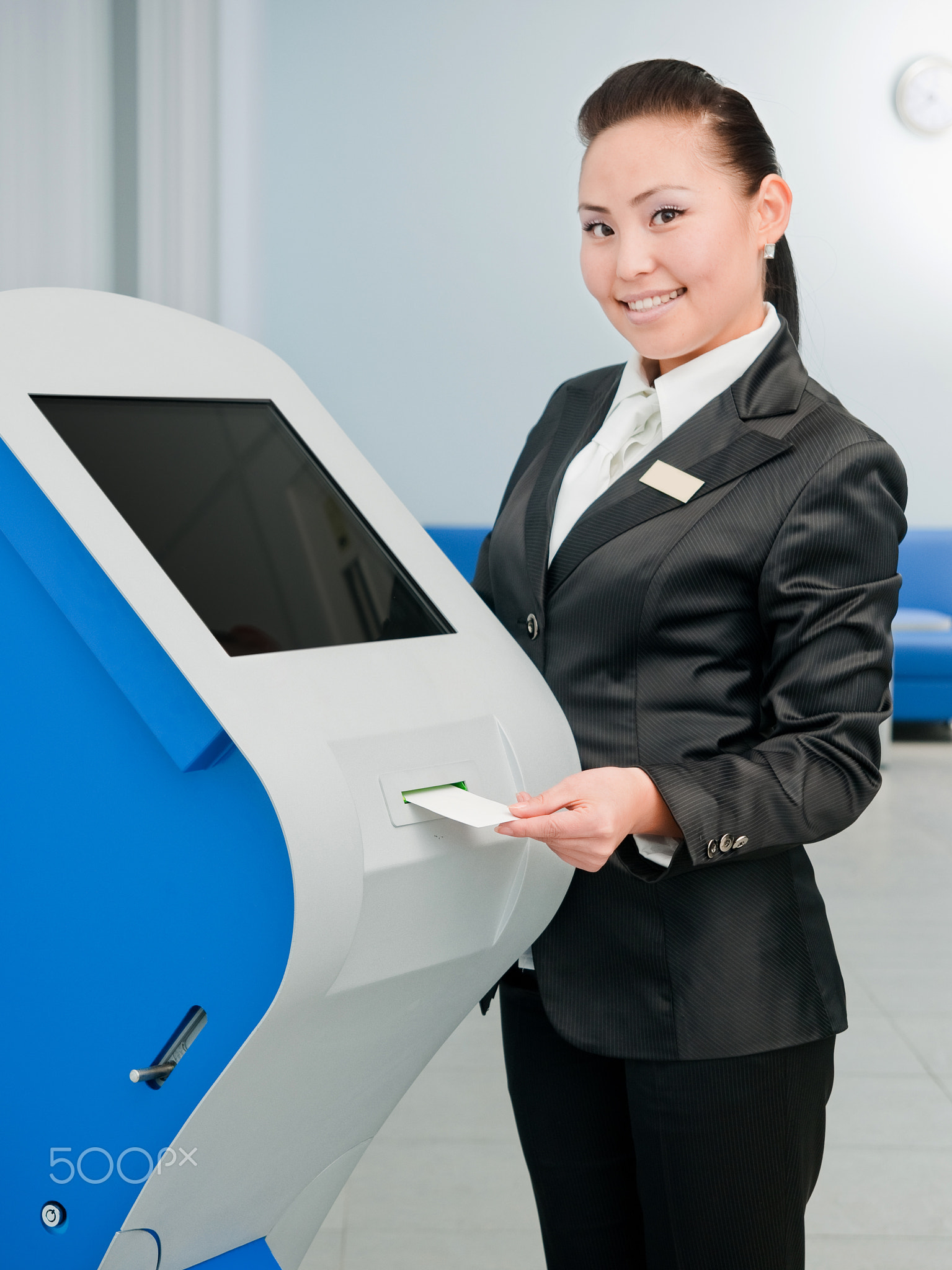 Bank worker by an ATM
