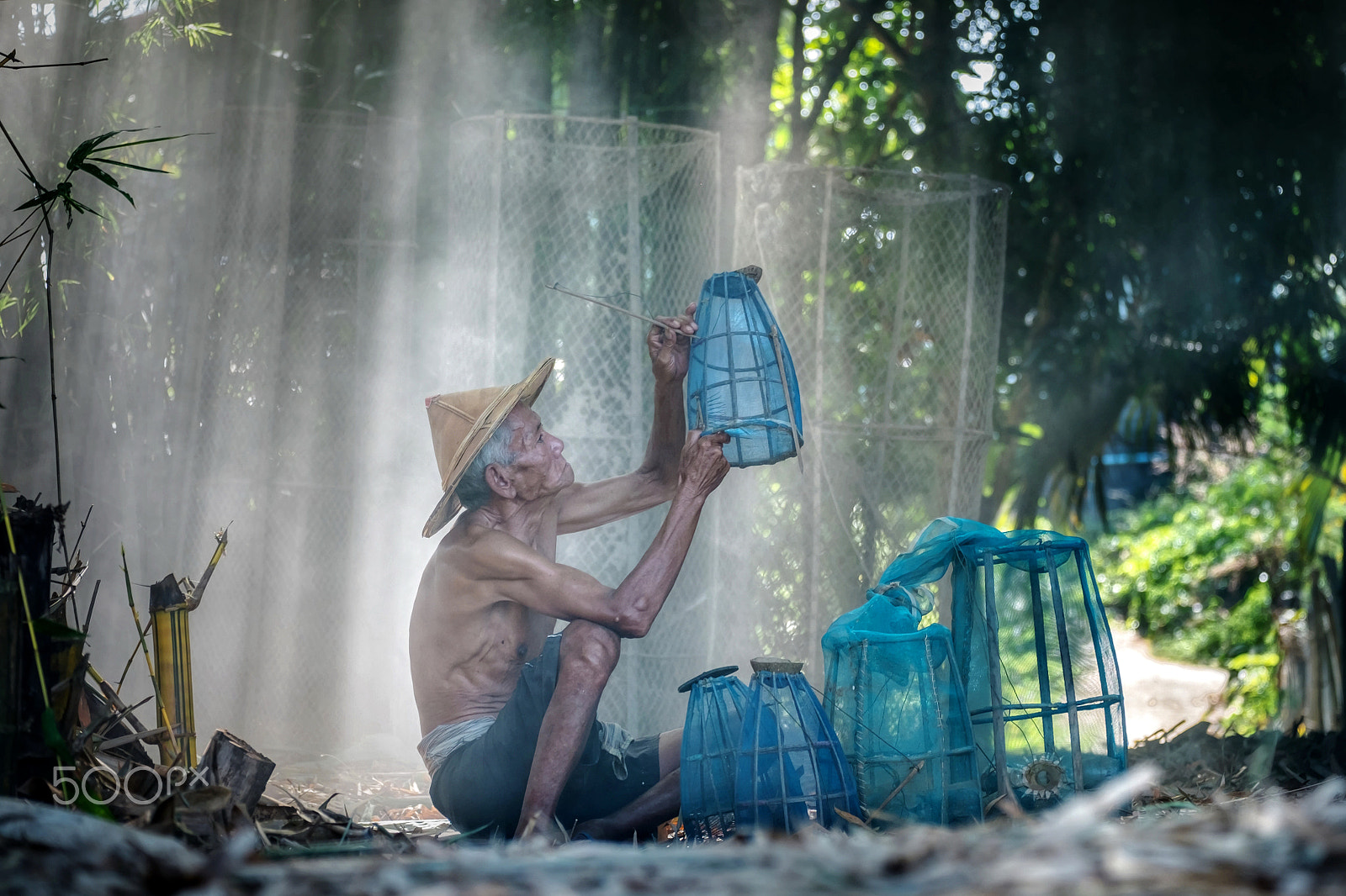 Fujifilm X-M1 + Fujifilm XF 55-200mm F3.5-4.8 R LM OIS sample photo. Fisherman repairing fishing tool photography