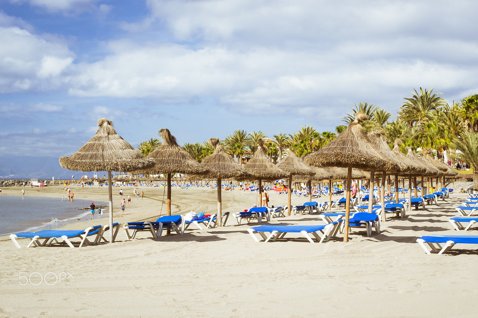 Nikon D3100 + Sigma 50mm F1.4 EX DG HSM sample photo. Straw umbrellas and loungers on the playa de las americas, tener photography