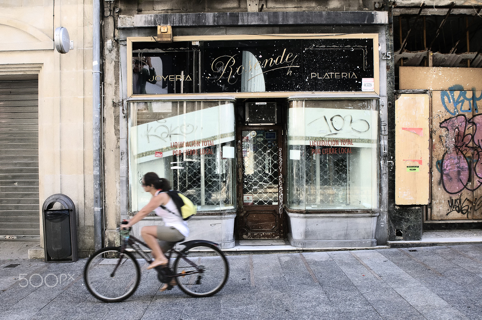Tamron SP 24-70mm F2.8 Di VC USD sample photo. Cyclist passing in front of a shop closed photography