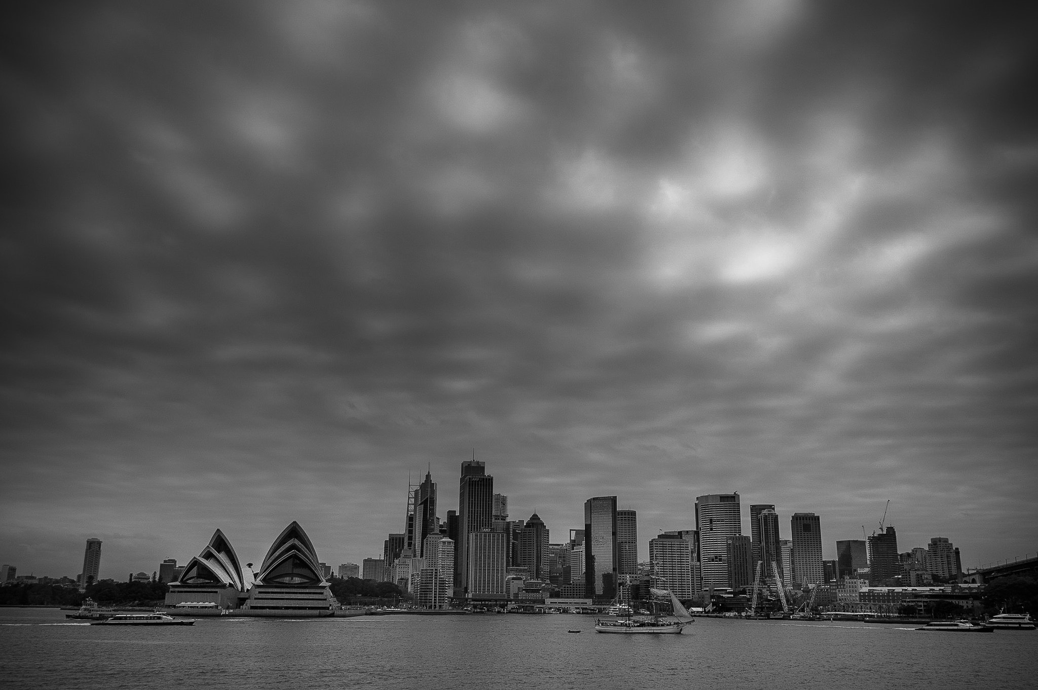 Sony Alpha NEX-5N + Sigma 19mm F2.8 EX DN sample photo. Clouds breaking over city photography