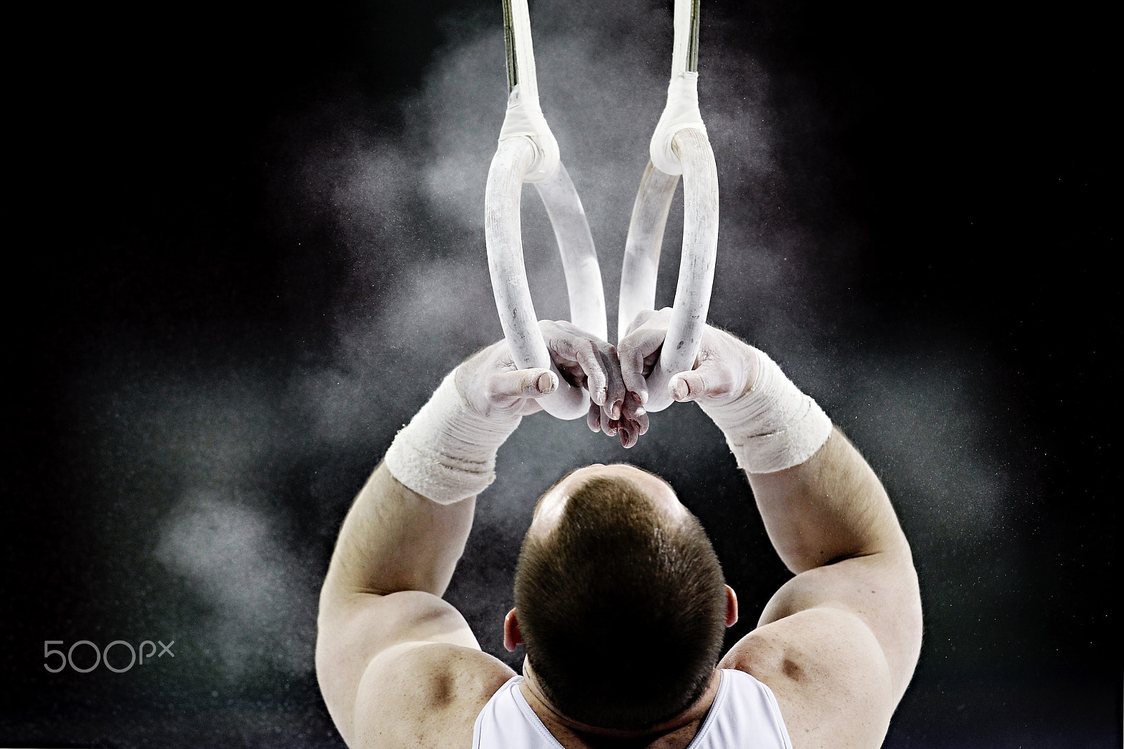 Canon EOS-1D Mark IV sample photo. Gymnast chalks up the rings photography