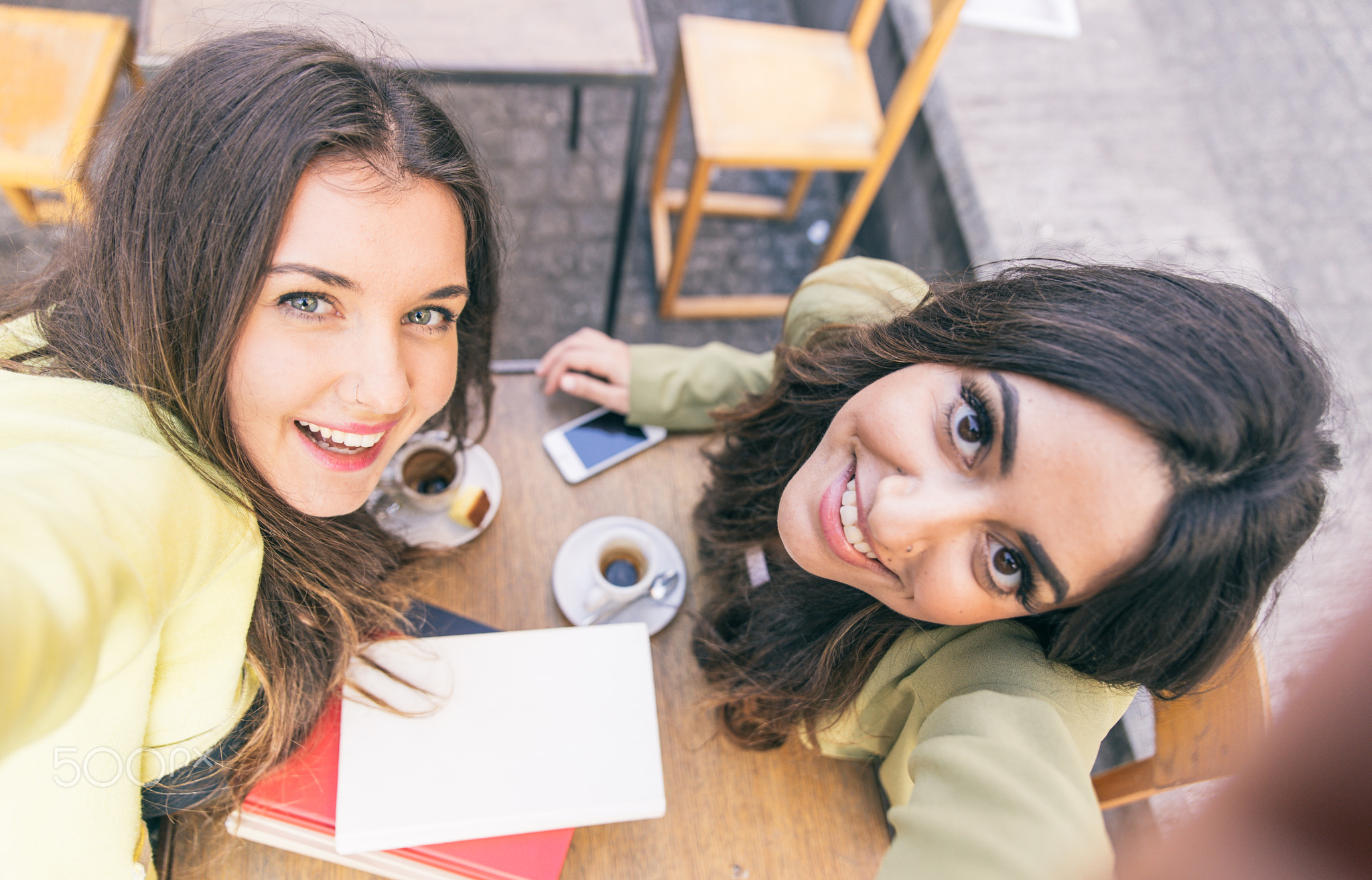 Two young women taking selfie with smart phone