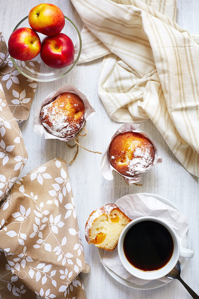 Breakfast table with cakes, coffee and fruits