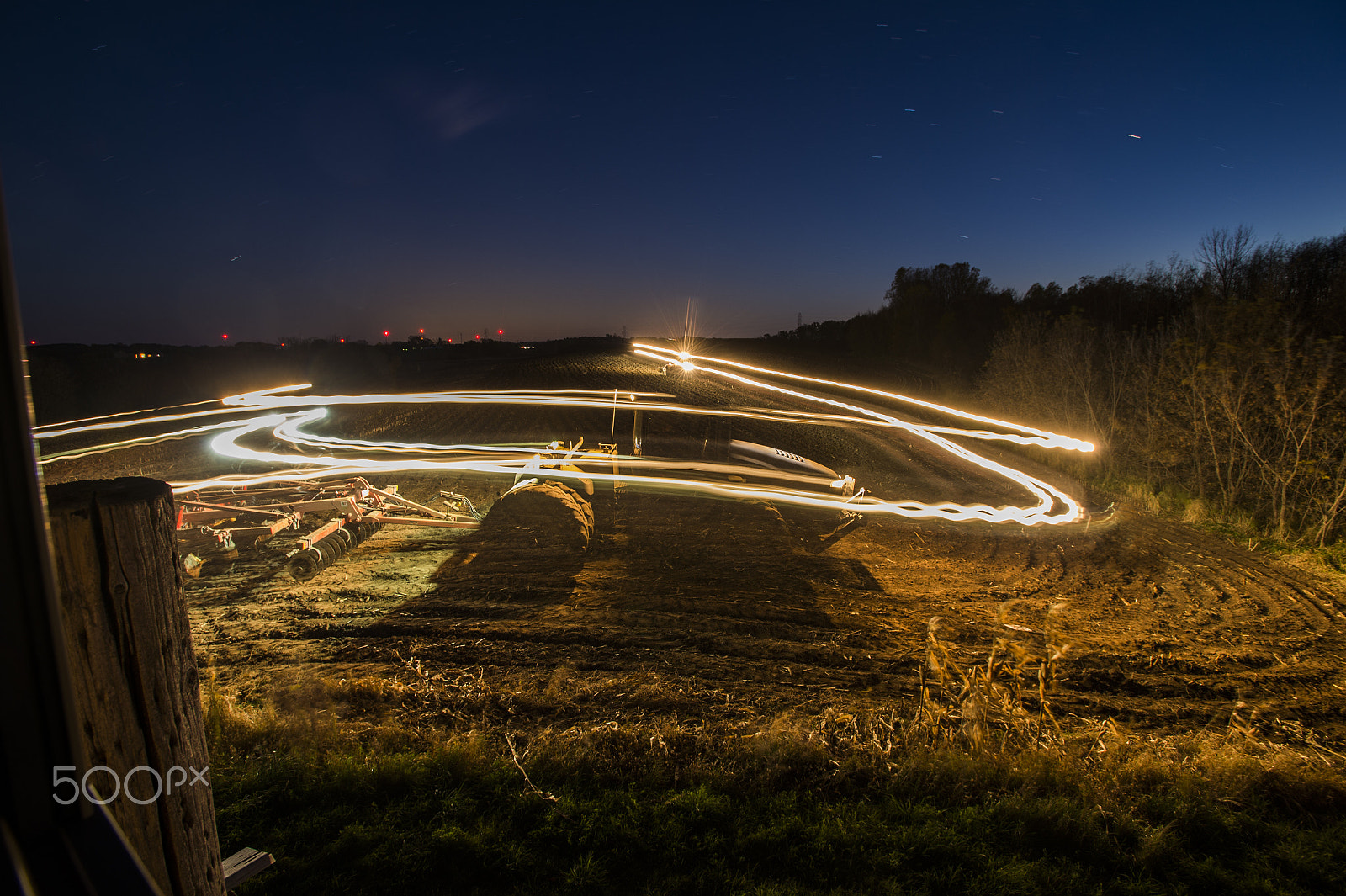 Nikon AF-S Nikkor 17-35mm F2.8D ED-IF sample photo. Farmer tills his field at night in fond du lac. photography