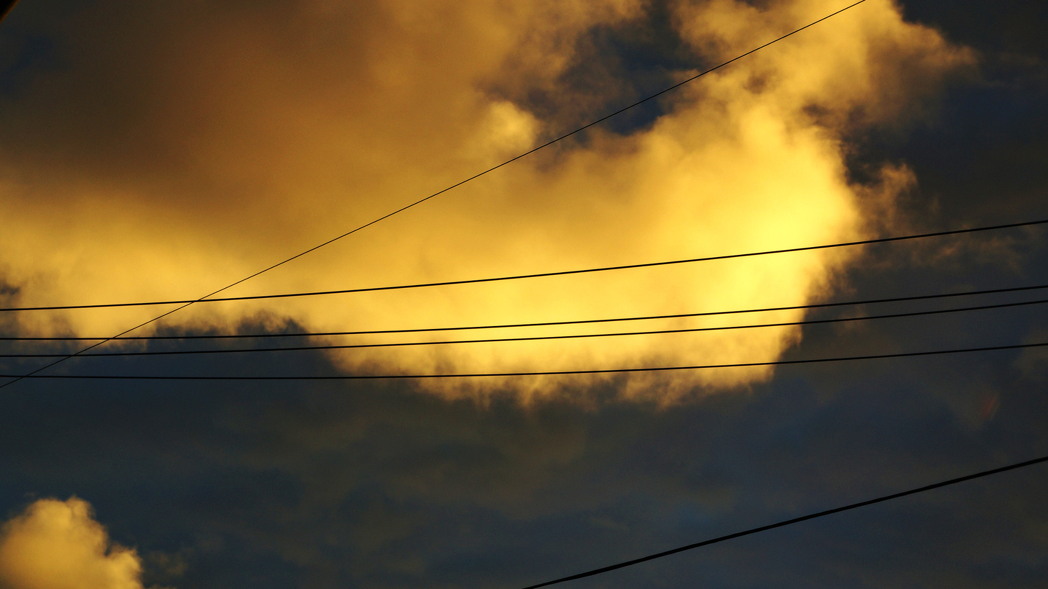 Sony Alpha NEX-5R + Sony E 18-55mm F3.5-5.6 OSS sample photo. Yellow cloud with power lines photography