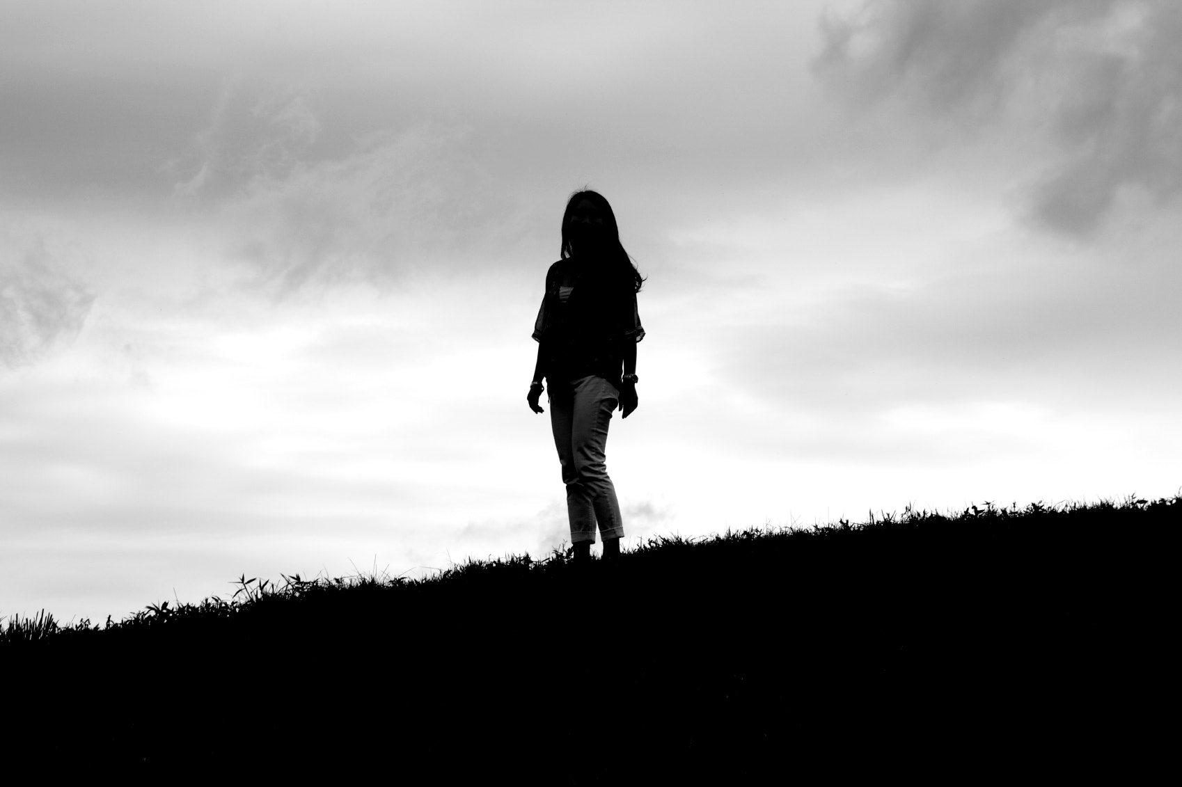 Sigma 17-70mm F2.8-4 DC Macro OS HSM sample photo. Silhouette of girl against overcast sky photography