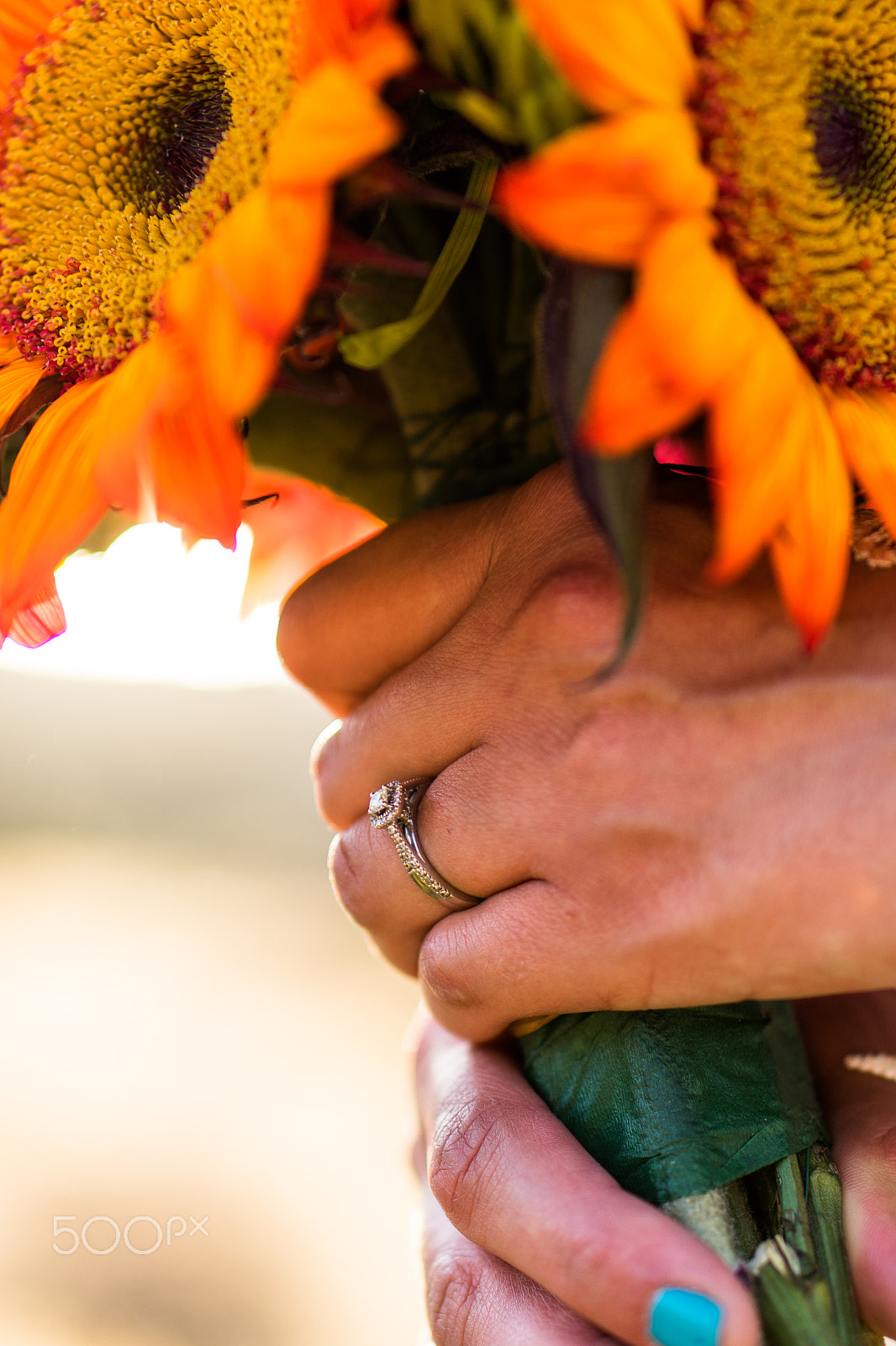 Sony a7R + E 50mm F1.8 OSS sample photo. A young woman grasping her wedding bouquet and showing off her ring photography