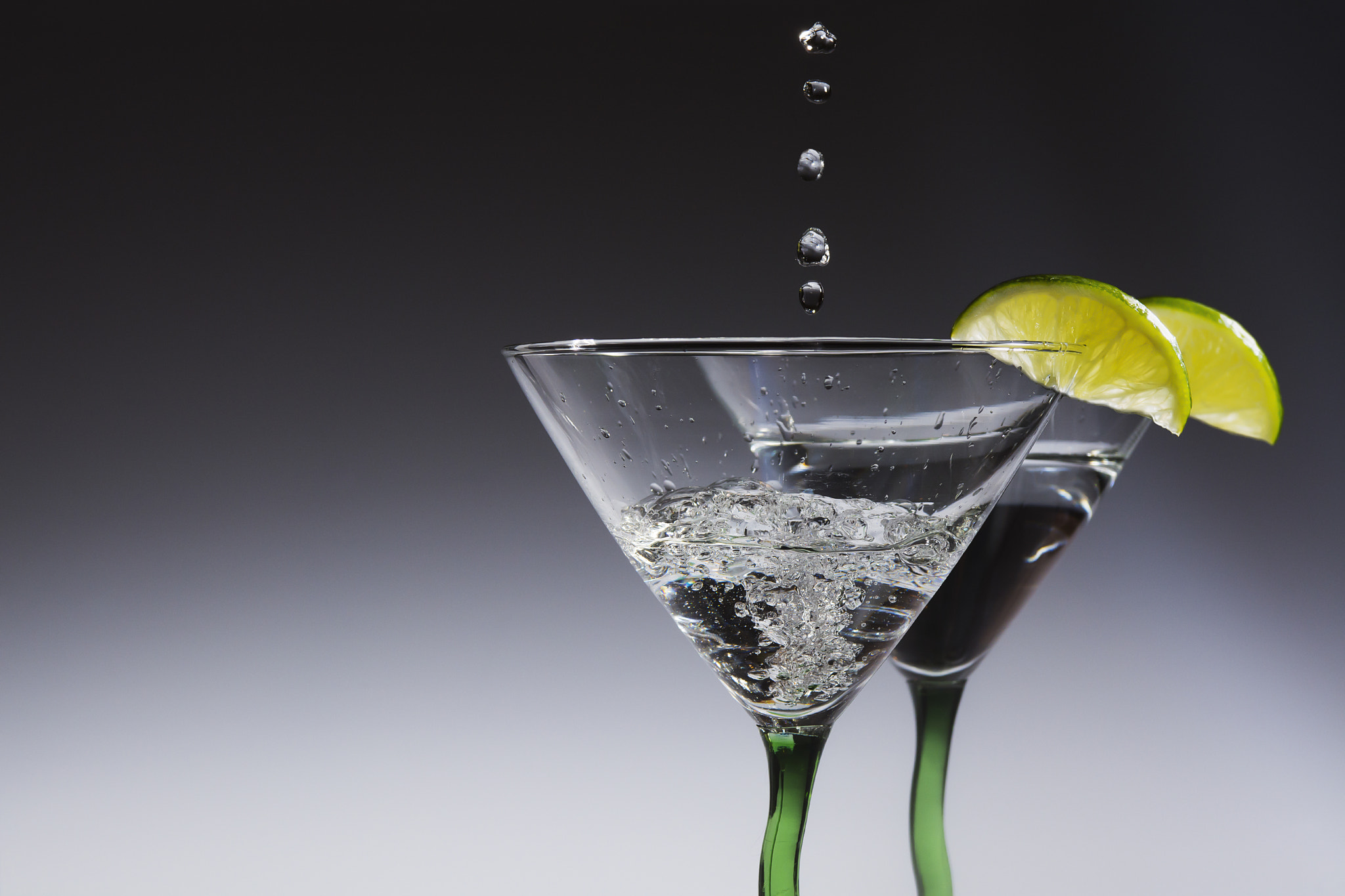 Nikon AF-S Nikkor 28-70mm F2.8 ED-IF sample photo. Martini glasses with limes and a splash photography
