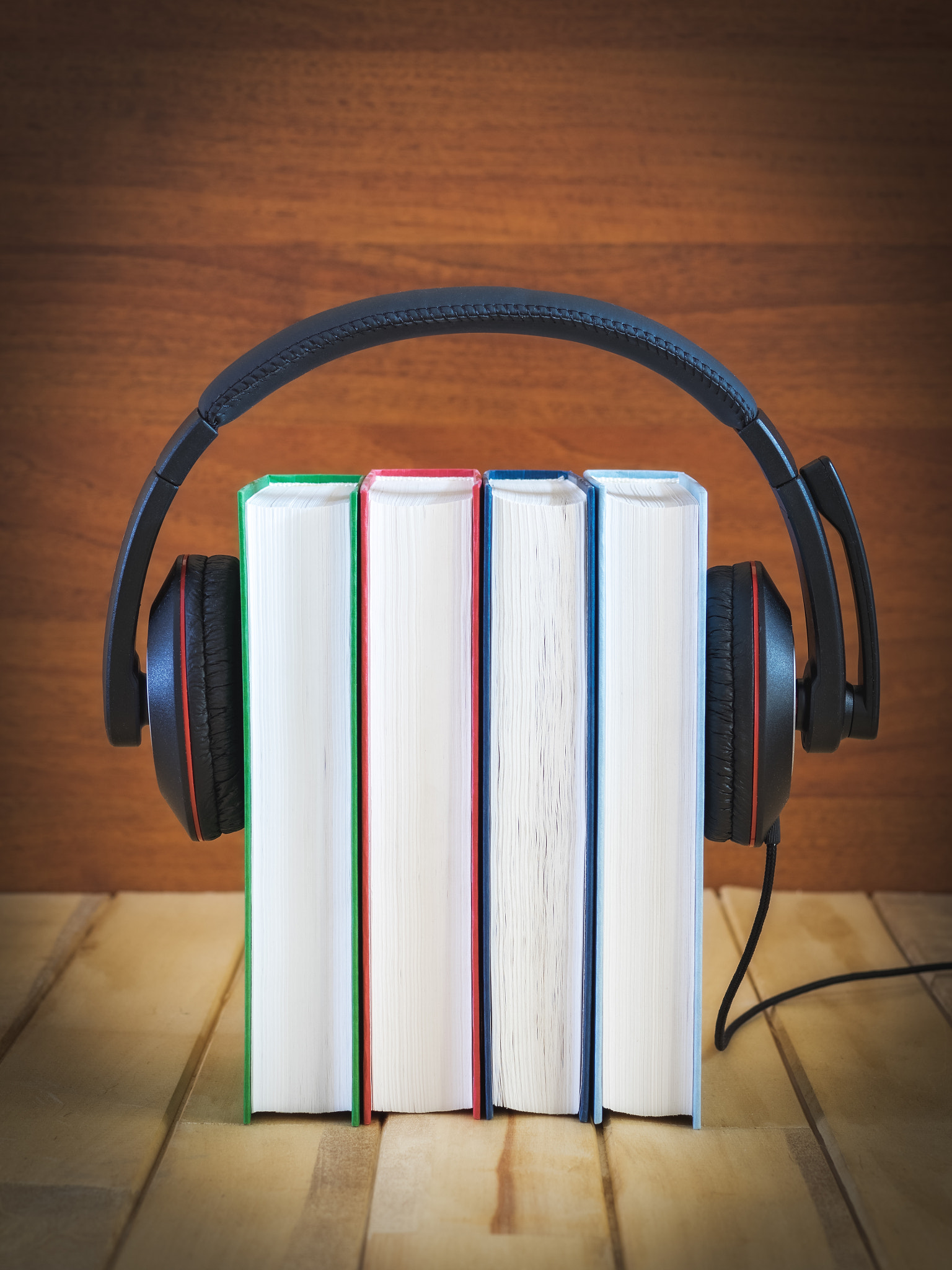 Olympus OM-D E-M1 + OLYMPUS 50mm Lens sample photo. Pile of books with headphones photography