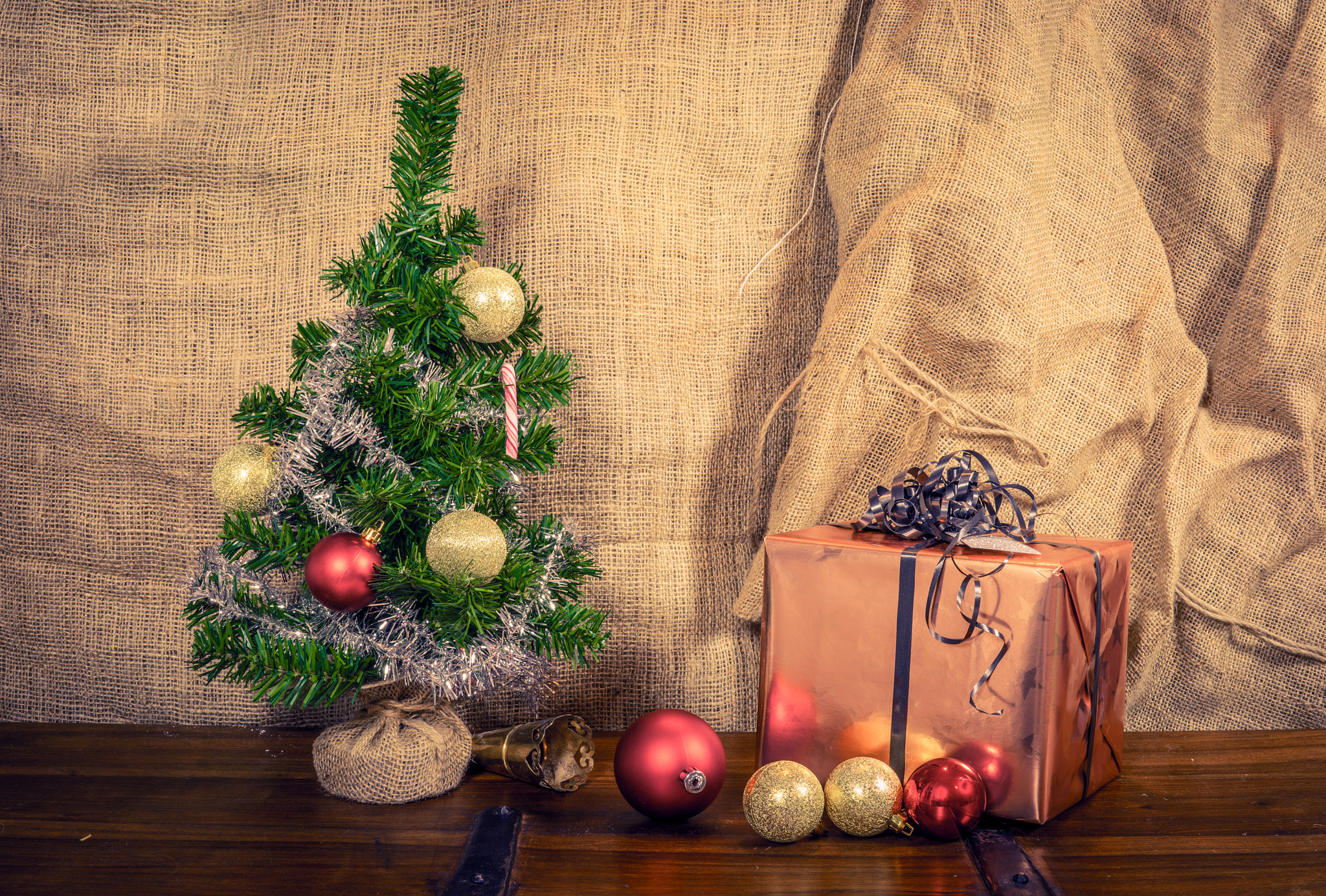 Sony a7R + Sony 50mm F1.4 sample photo. Shiny christmas presents on a table photography