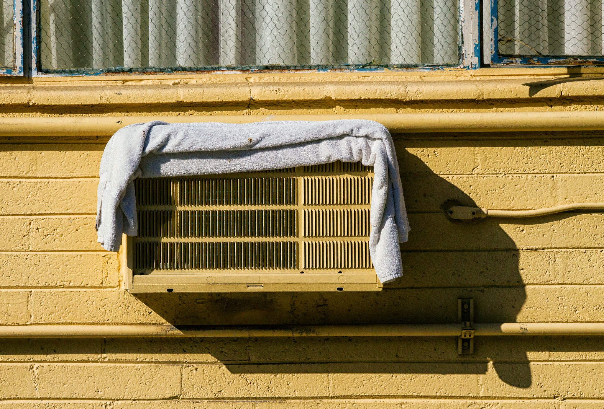 Olympus PEN E-P3 sample photo. Air conditioner with towel photography