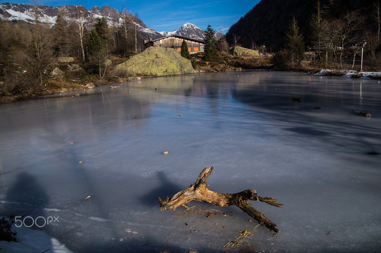 Tamron 18-270mm F3.5-6.3 Di II PZD sample photo. Frozen lake with dead wood in the french alps photography
